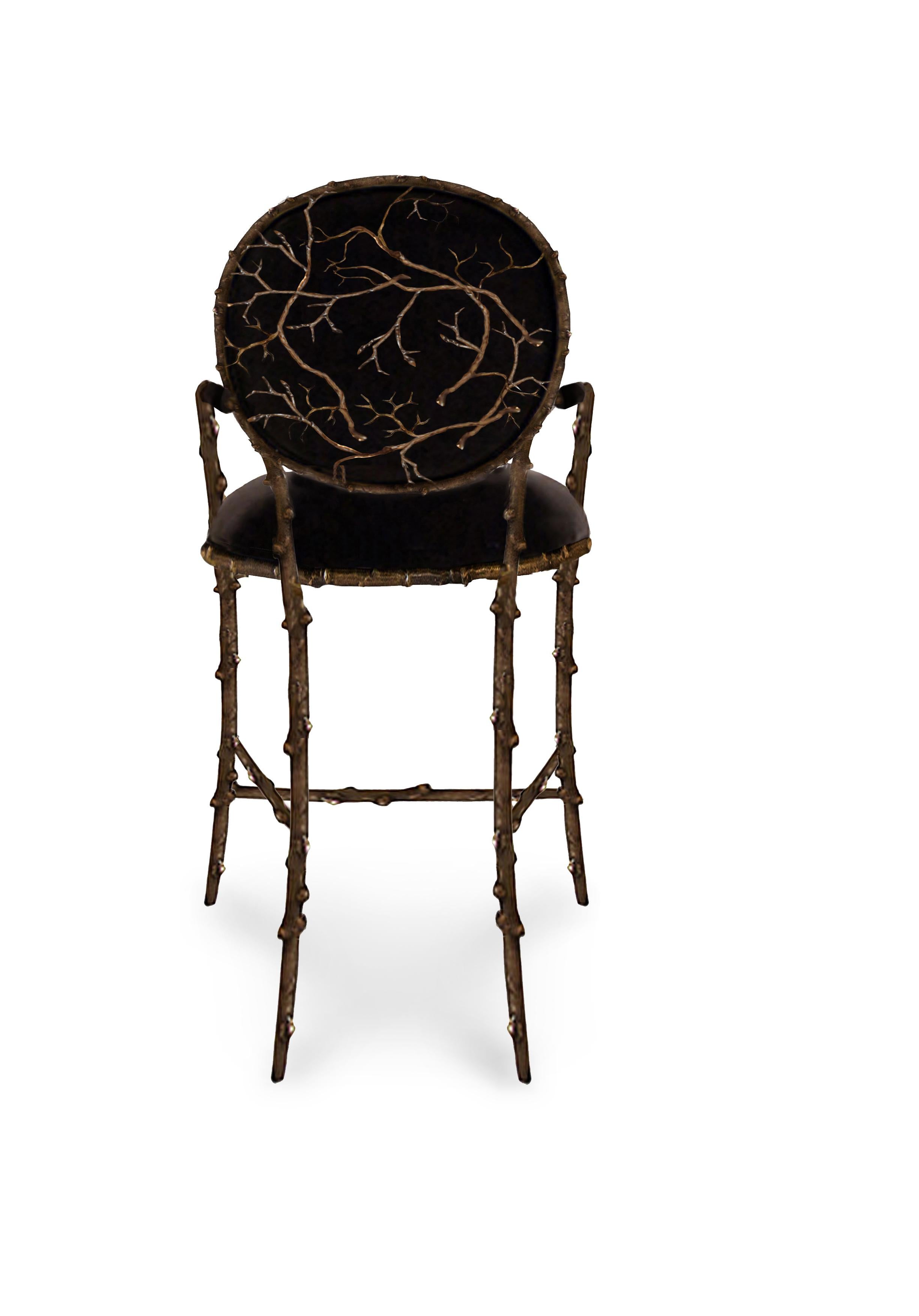 Our artisans have masterfully captured the alluring essence of an enchanted forest with this bar stool. Its antique gilded branch like structure can't help but mesmerize the beholder. Her fully upholstered body pops as the backdrop to the glinting,