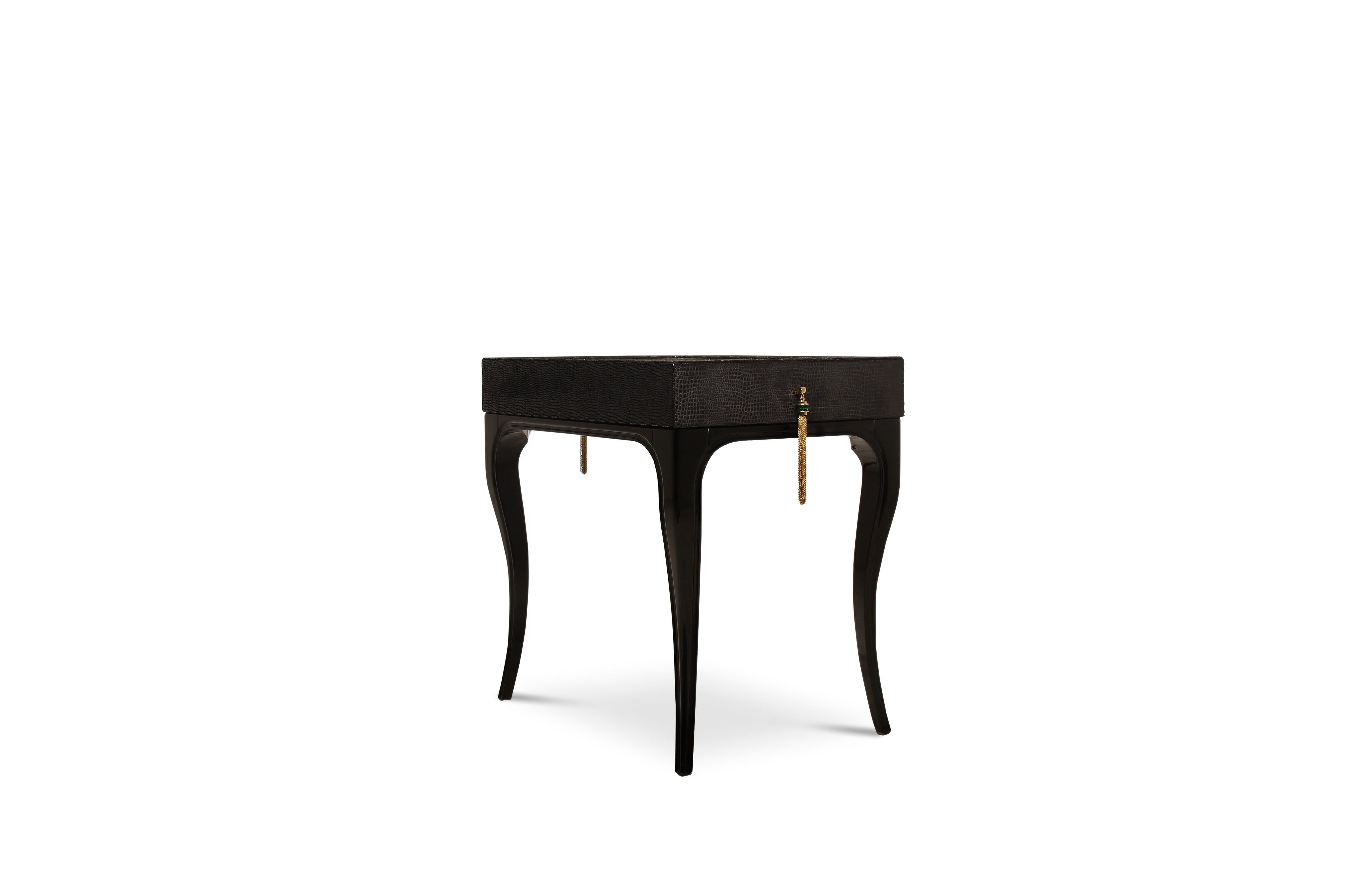 Exuding feelings of fantasy, this highly coveted nightstand is bold, daring and seductive. Her wooden frame is cloaked in an exotic fabric with a complementing metal top, juxtaposed with the mesmerizing movements of shimmering glass tassels.

Top: