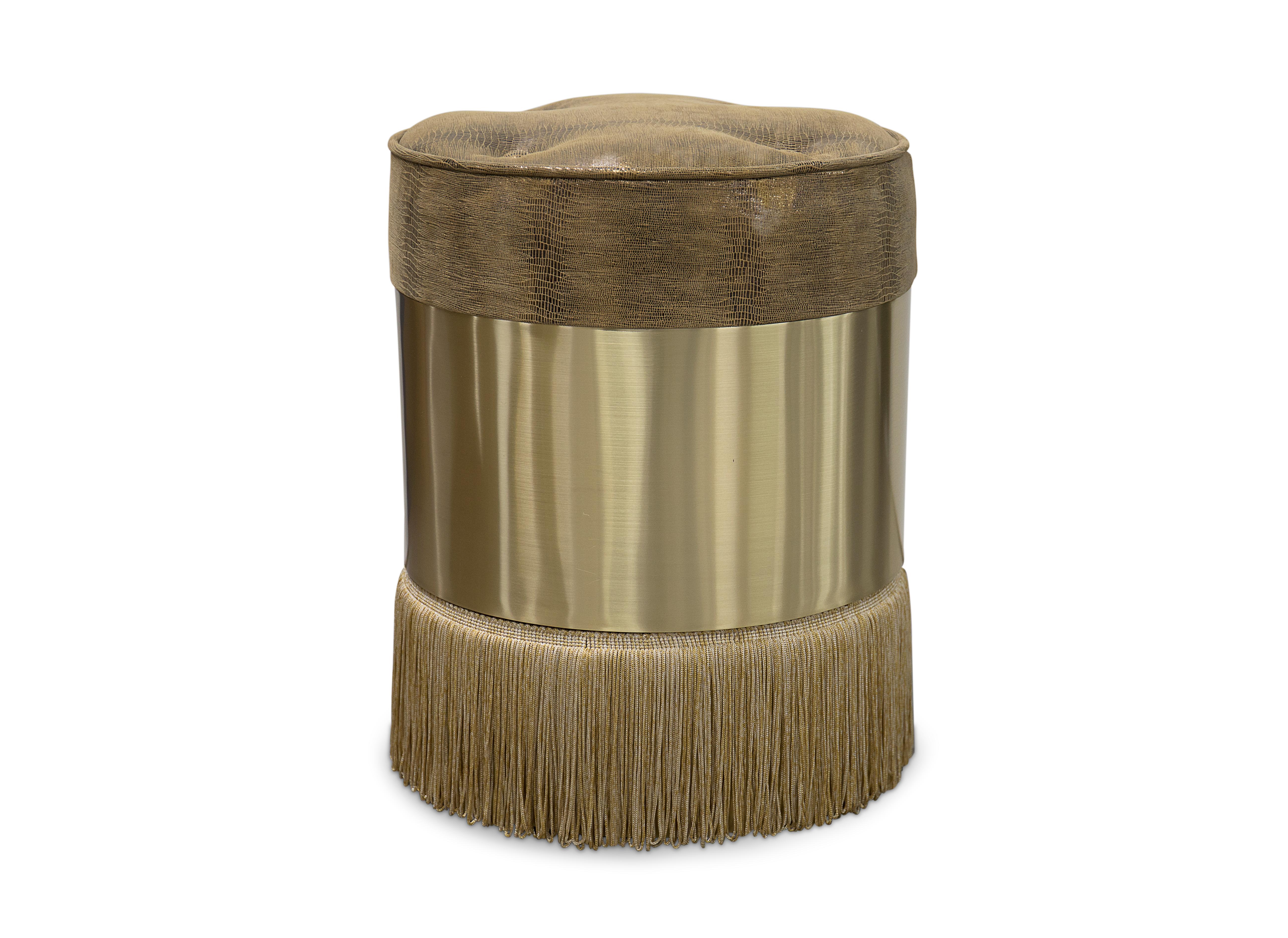 Each of these fashionable pouf stools feature their own unique combination of contrasting materials. One of a trio of Koket pouf designs, the tailored button tufted seats, polish brass belts and flowing fringed skirts make this lovely lady the