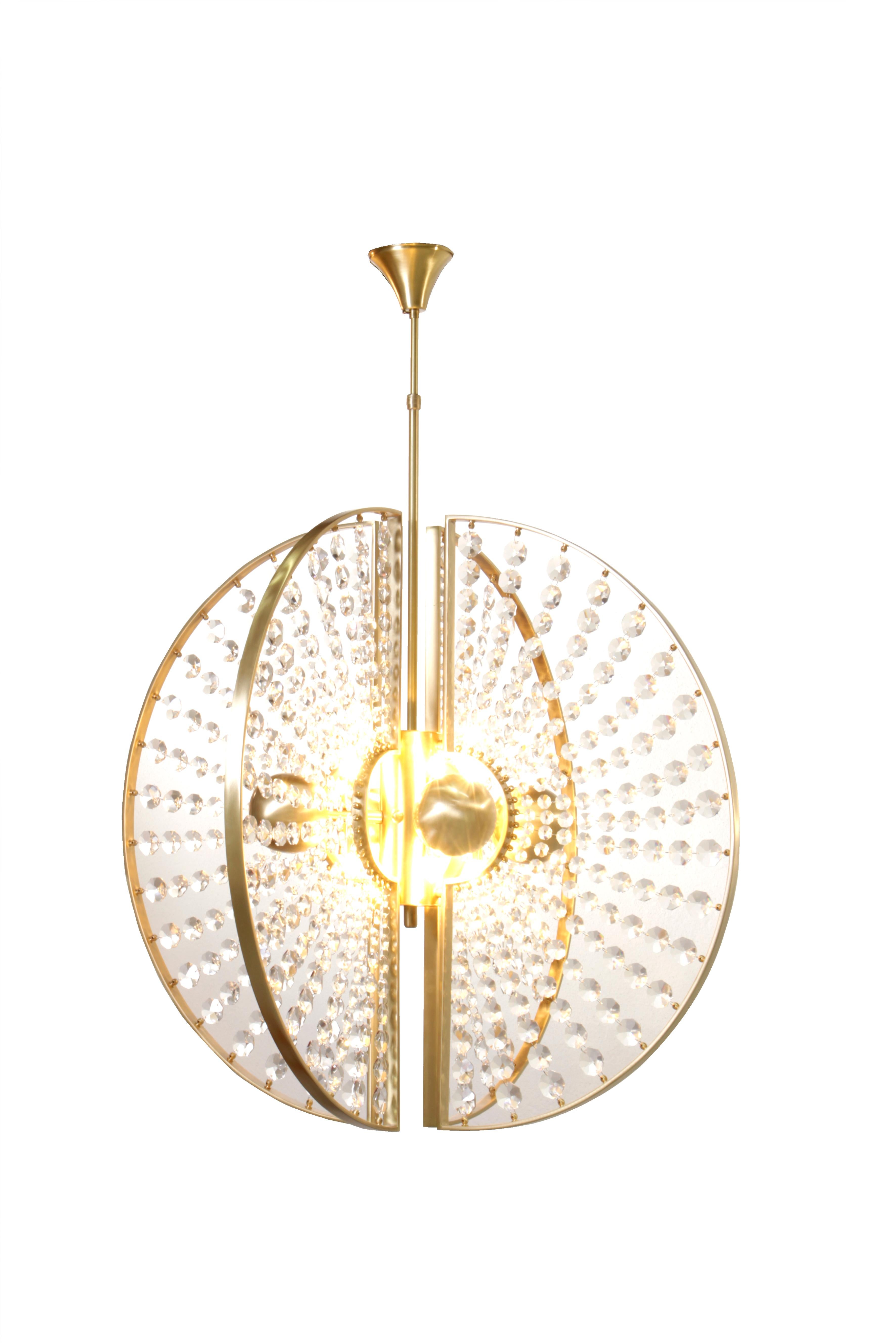 The Roxy chandelier is just as thrilling and desirable as her name implies. Four decadent metal orbs are surrounded by glittering crystal sunburst panels surrounded by a metal halo. Look too closely and this luxury chandelier will steal your