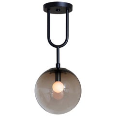 Koko, a Modern Pendant Light with Satin Globe Shade in Matte Black and Bronze