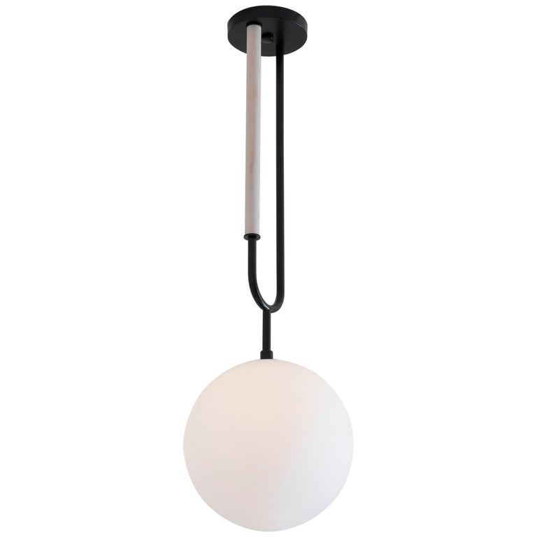 Drawing inspiration from a pearl pendant, the Koko line is elegant and modern, with its luminous blown glass and brass arch detail. A versatile light, Koko can be displayed as a single pendant or arranged in a grouping as a chandelier.

This