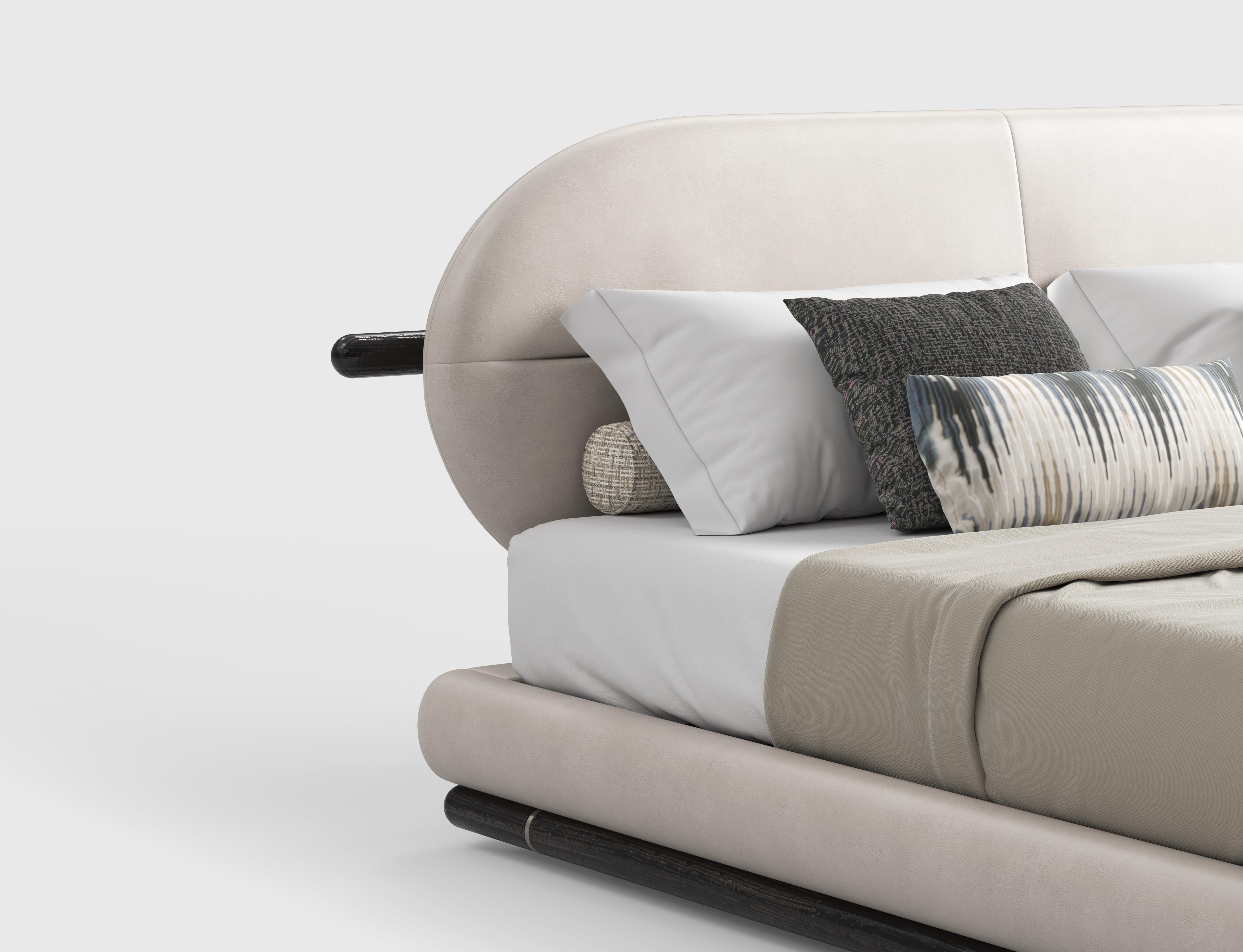 This bed features a sturdy wooden frame, combining durability with a timeless aesthetic. The structure can be upholstered in either fabric or leather, allowing for a customized look that suits different interior styles. The headboard stands out ith