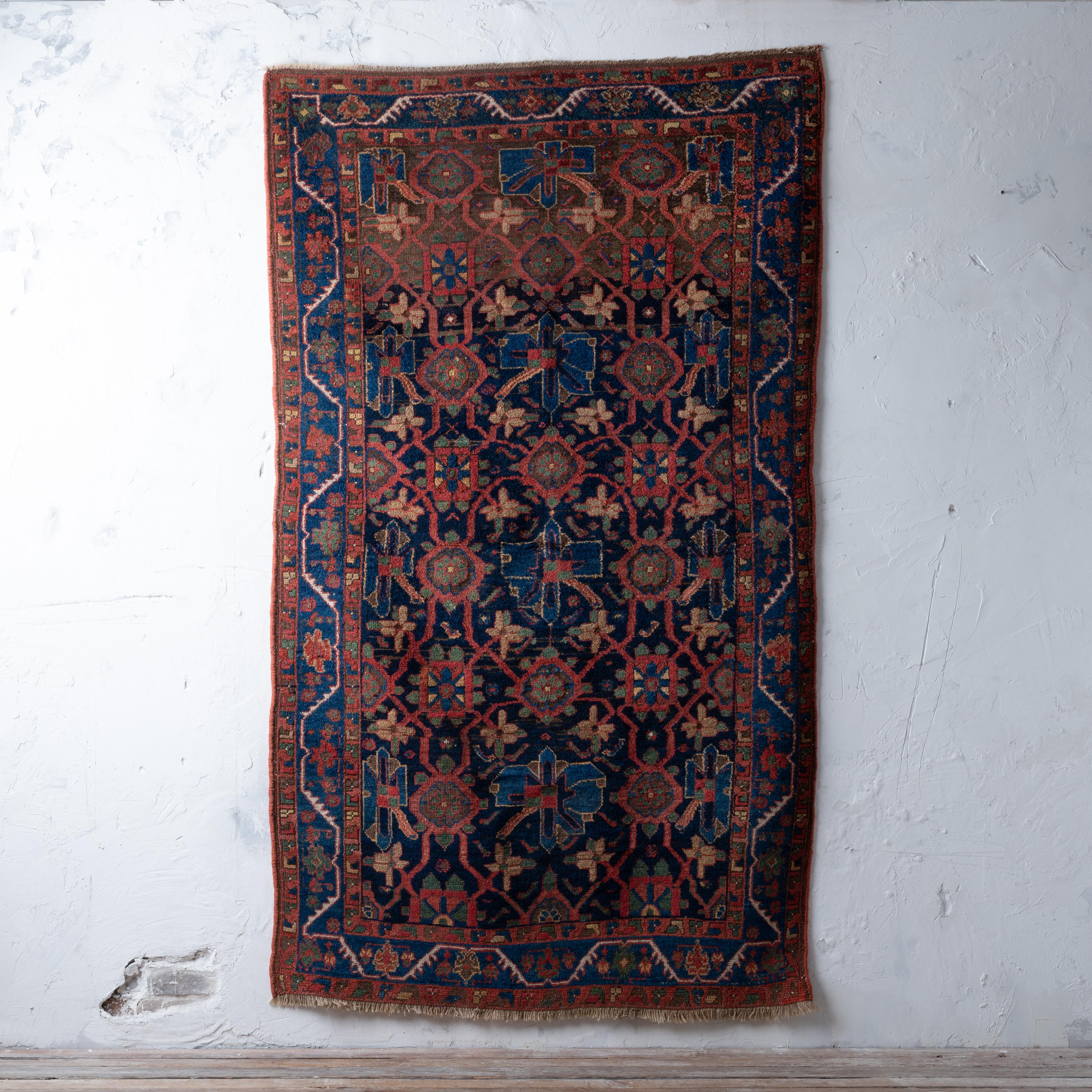 A Koliya’i rug with mina khani lattice field, circa 1920s.

51 by 87 inches

