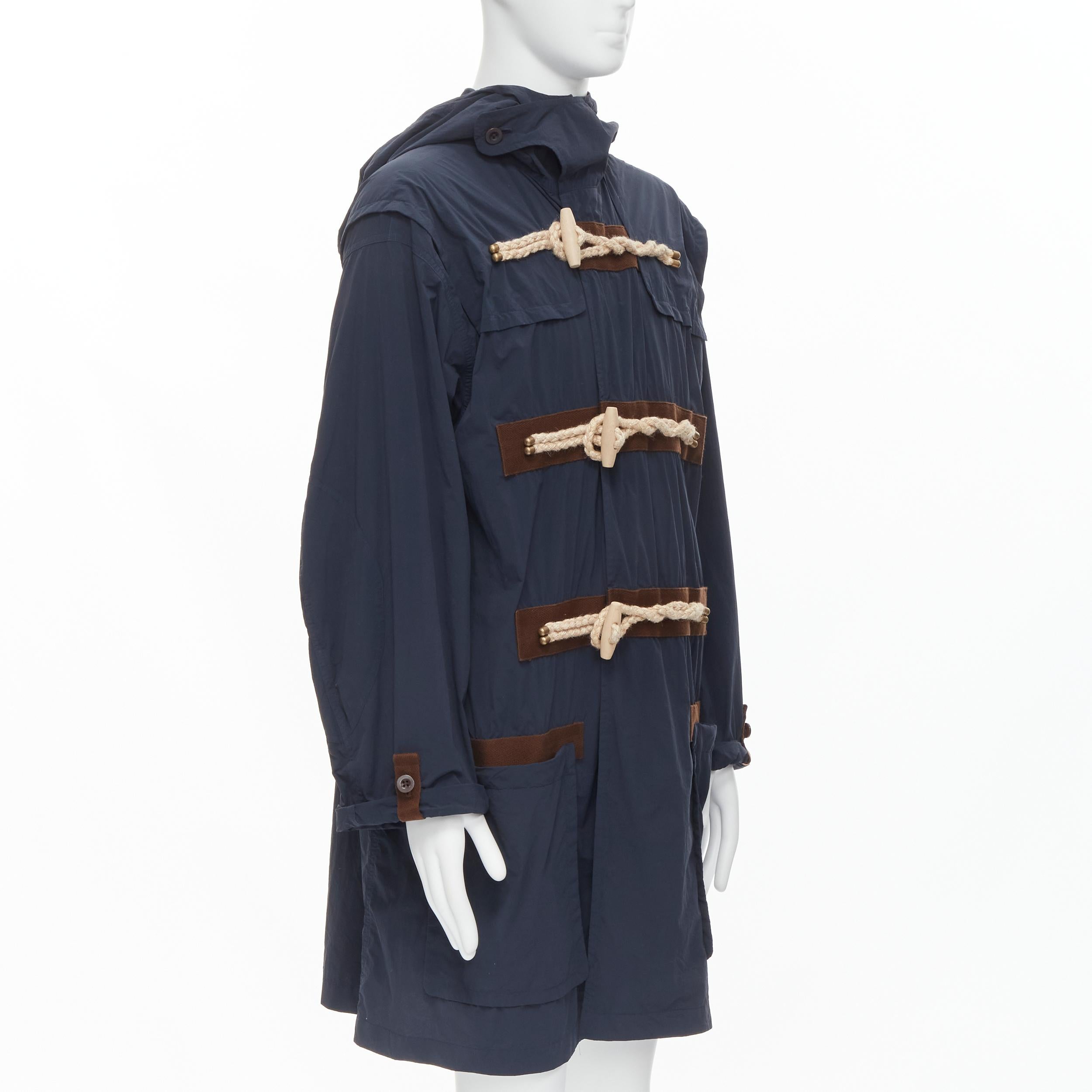 KOLOR navy blue rope wood toggle button anorak parka jacket JP2 M 
Reference: CAWG/A00214 
Brand: Kolor 
Material: Nylon 
Color: Navy 
Pattern: Solid 
Closure: Toggle 
Extra Detail: Rope and wood toggle button. Hooded parka. Double patch pockets at