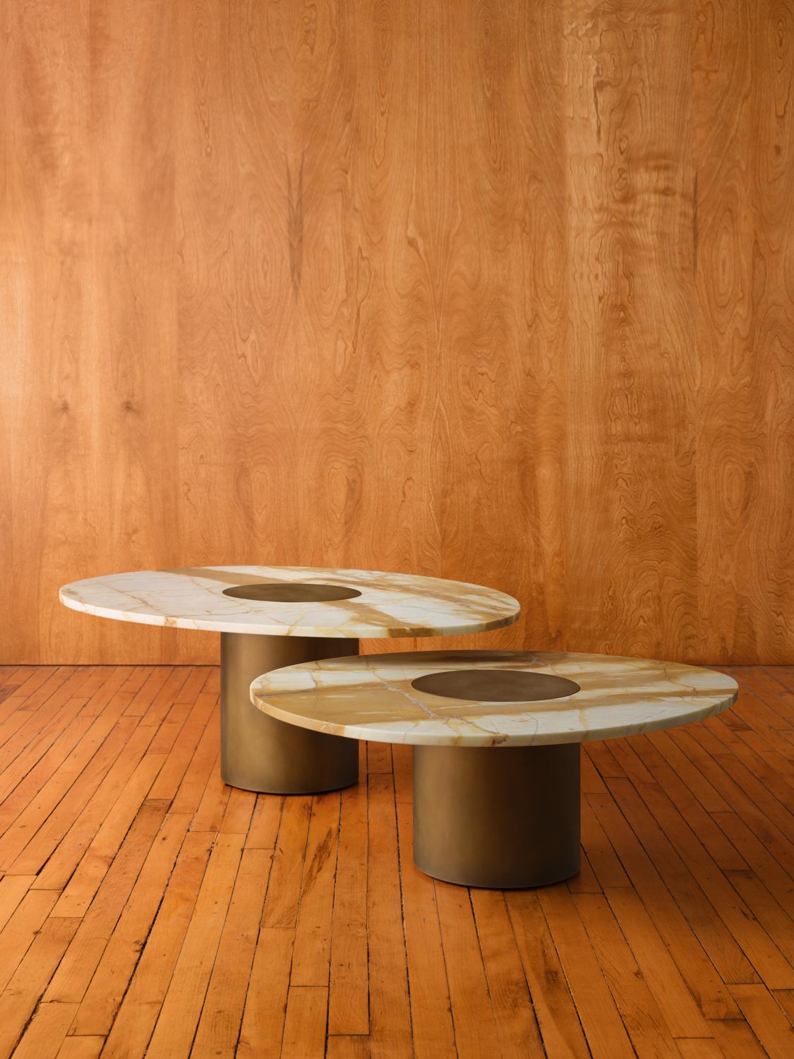 Inspired by the form and function of grain silos, the sculptural Silo Coffee Tables feature a solid wood or marble top with hand-finished brass or stainless steel wrapped legs. 

This listing is for a pair of nested Small 
Medium Silo Coffee