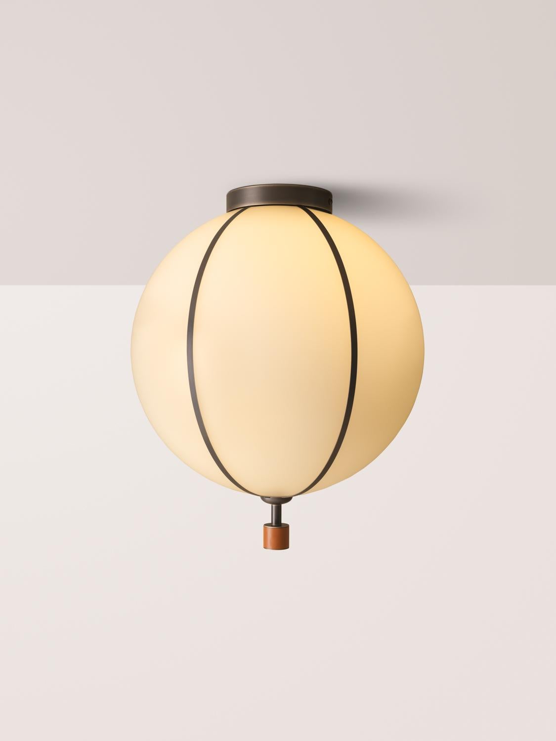 The Rib Flush Mount - Large Sphere is blown in Italy and delicately framed by thin brass ribs. A cylindrical brass finial, with optional hand-wrapped leather or suede, elongates the fixture and adds a finishing touch of refinement.

Available in a