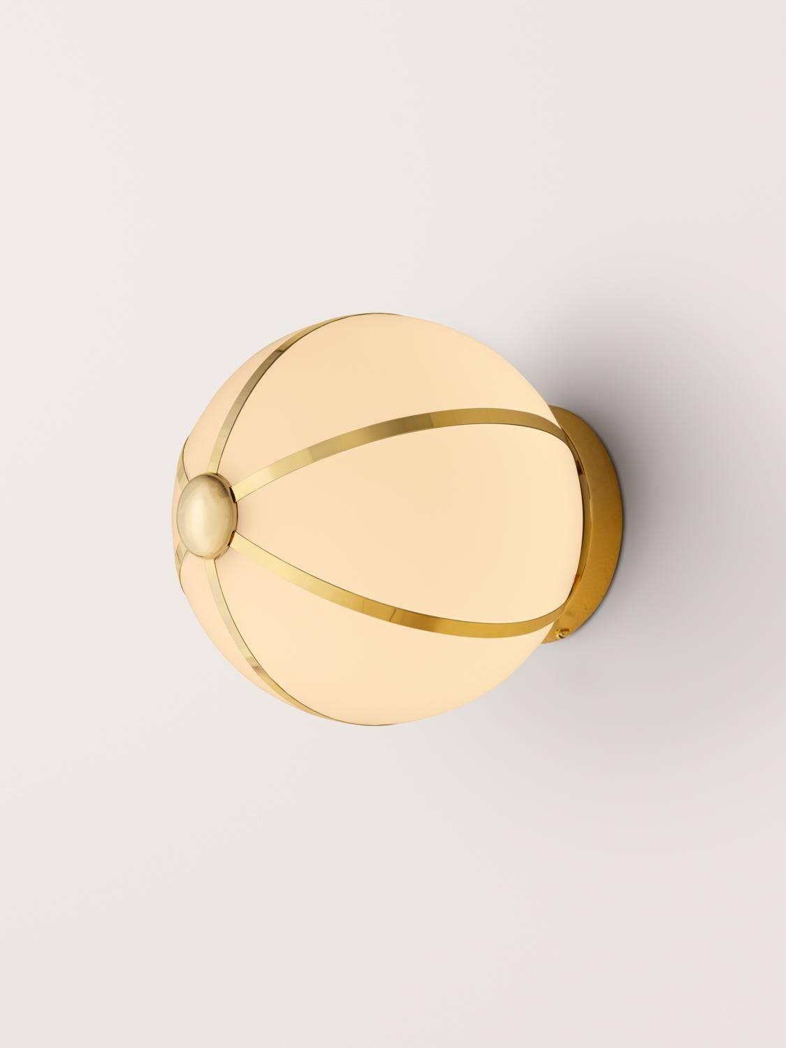 The Rib Sconce - Small Sphere is blown in Italy and delicately framed by thin brass ribs. Can also be used as a ceiling flush mount.

Available in a variety of metal finish options.

