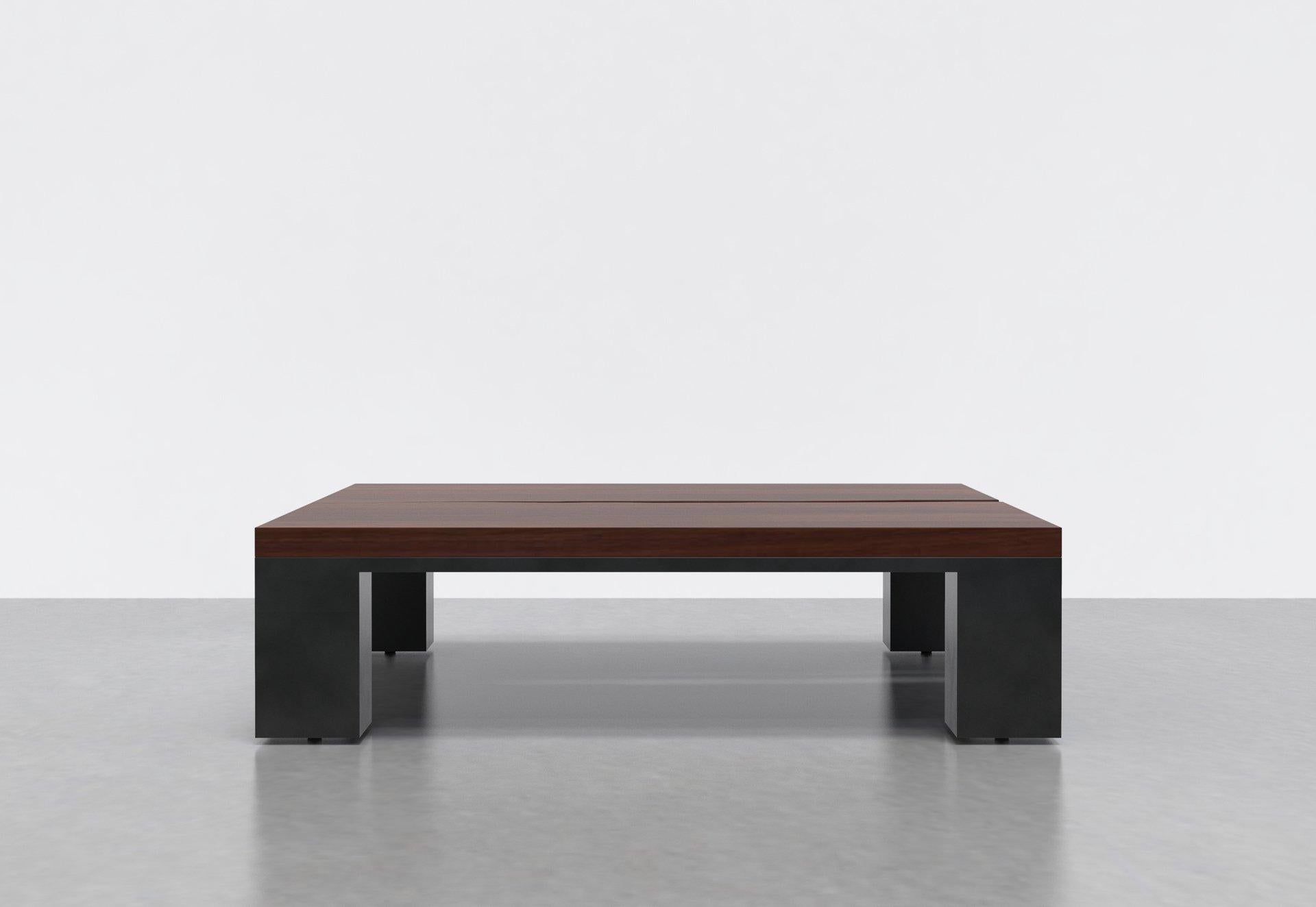 The Kong Coffee table is created from a solid wood top in a walnut finish, set on a steel frame. Its visual balance of form and weight creates a dynamic contrast with the organic edge detail towards the center of the table top. The Kong Coffee