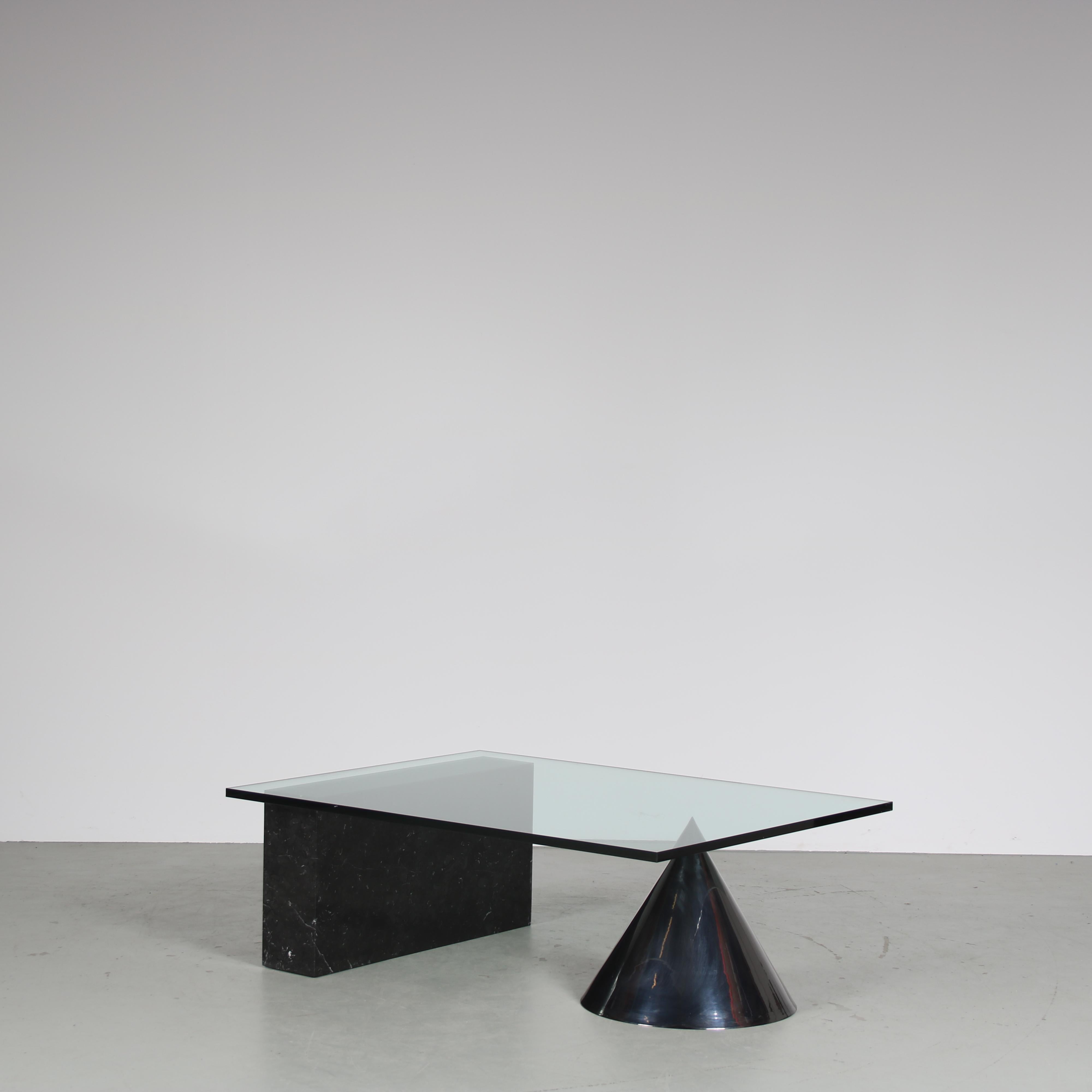 A stunning 1980s coffee table model “Kono,” designed by Massimo and Lella Vignelli and manufactured by Casigliani in Italy.

This coffee table features a glass top that allows for a clear view of the exquisite base. The base is a combination of one