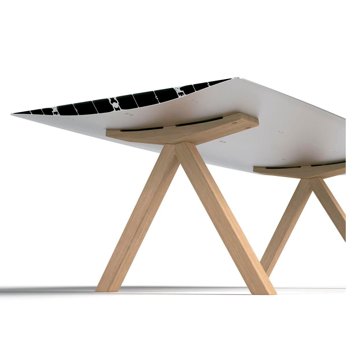 Top in bevel edged extruded aluminum. Surface laminated in oak effect. Natural ash wooden legs.

Measures: 120 D x 360 W x 73.5 H cm.

Reddot design award best of de best 2011.

Tabletop in extrusion aluminum with open ends cut at 45º.

The