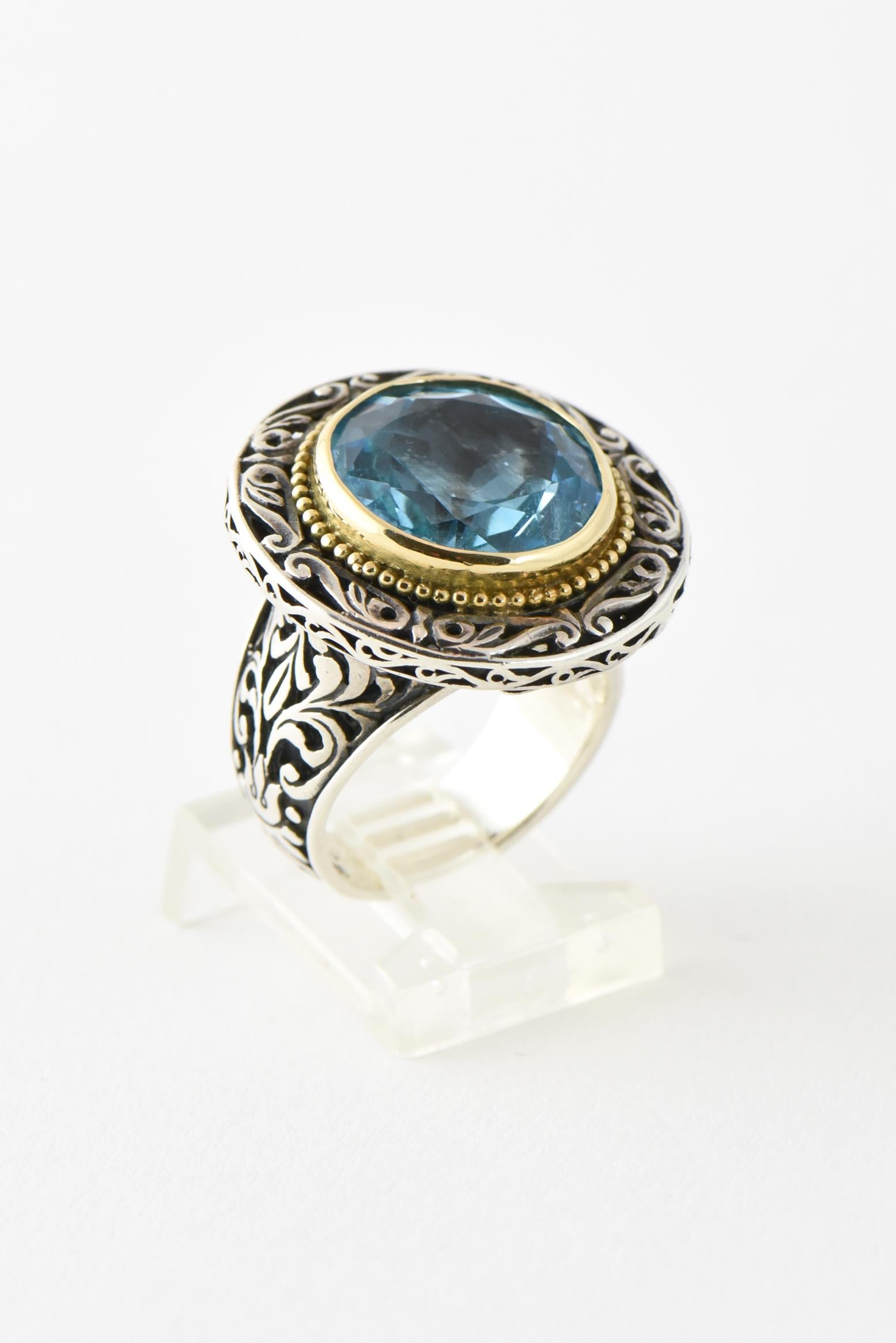 Konstantino sterling silver ring featuring filigree openwork frame and band with 18K yellow gold bezel-set faceted round blue topaz. Marked: 750, 925 and Konstantino. U.S. ring size: 5.75. Minor wear.

Konstantino - Enthralled with Greek history and