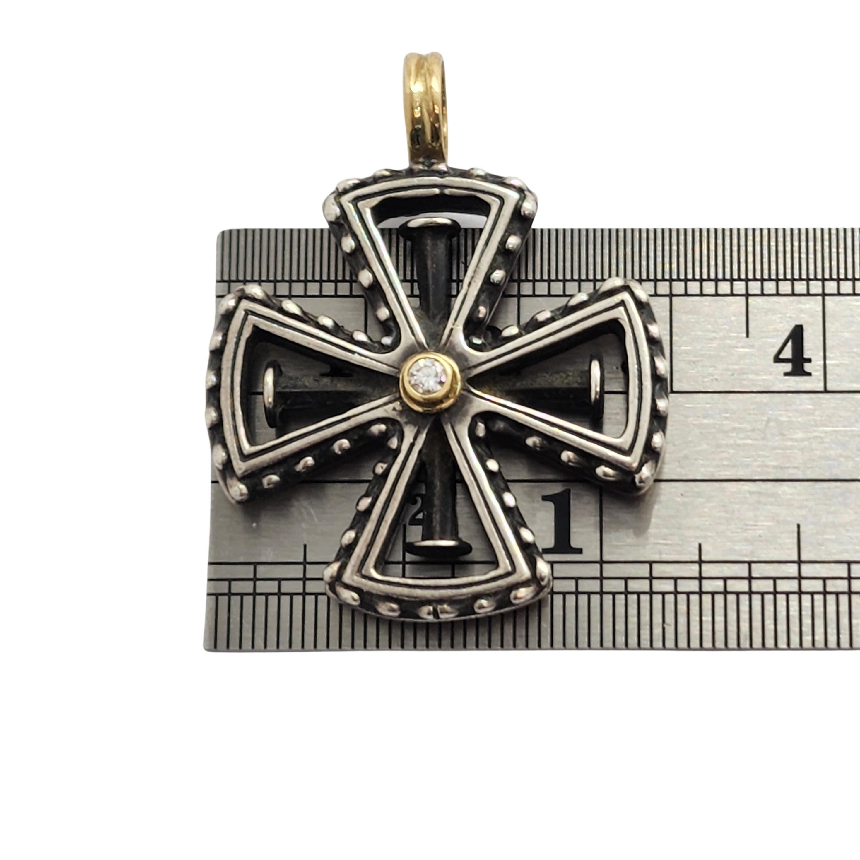 Sterling silver and 18K yellow gold cross with diamond by Konstantino.

A sterling silver in a knights Templar cross design with 18K yellow gold accents and a .07ct round diamond at the center in an 18K yellow gold bezel.

Measures approx 1 1/2