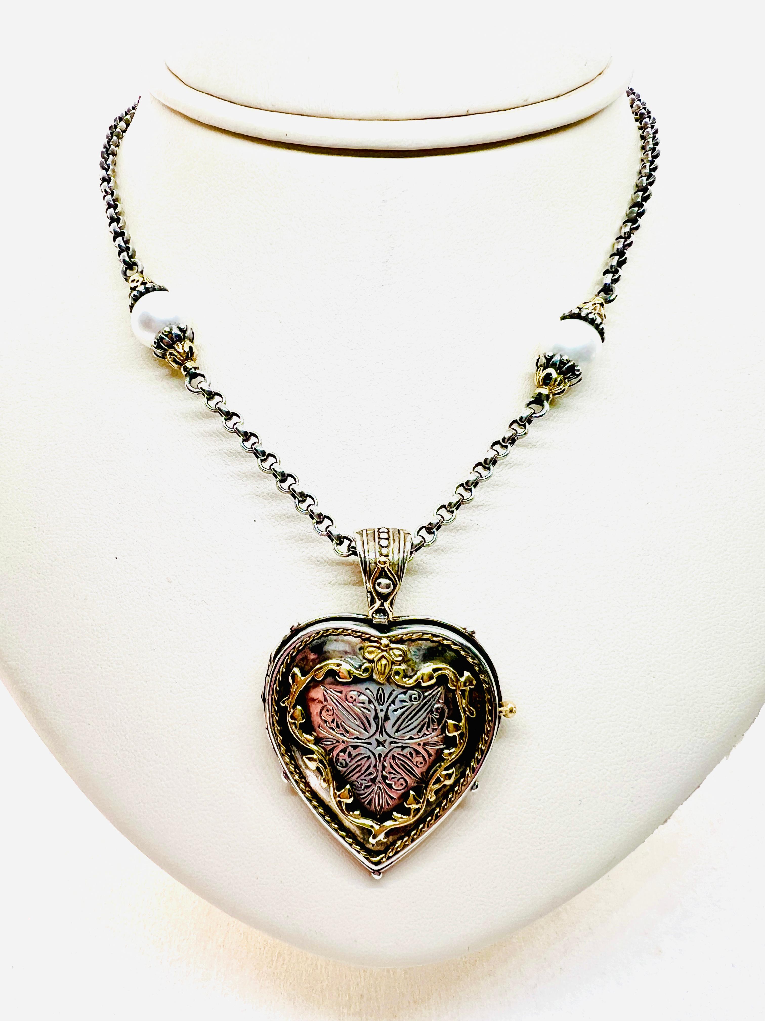 Gorgeous Konstantino Necklace with heart locket pendant / enhancer. the necklace is in 18 k Yellow gold and sterling silver. It features 4 , 8mm pearl stations. The heart pendant / enhancer measures 2 inches by 1.5 inches. The heart is stamped