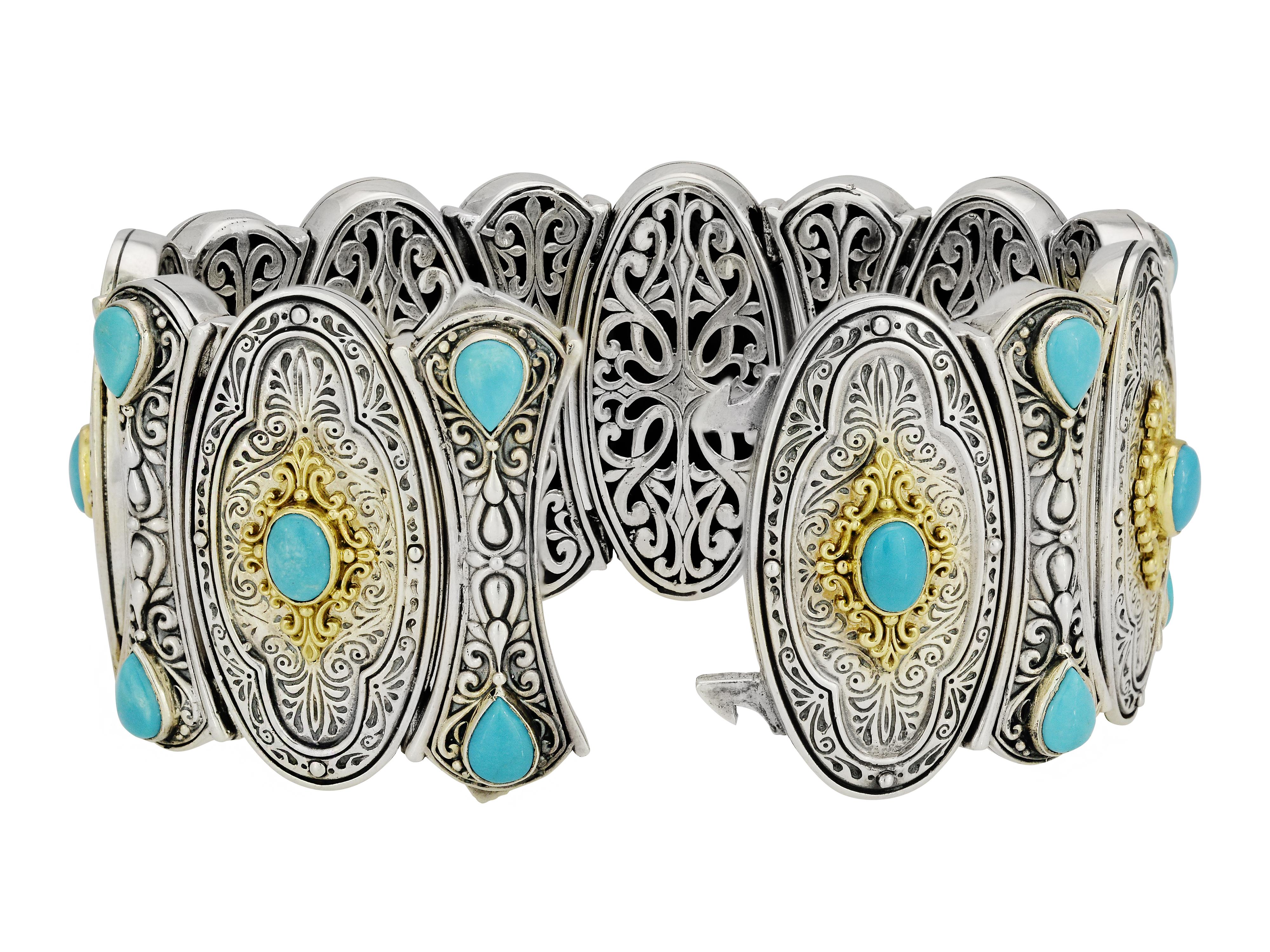 Wide Sterling Silver and 18 Karat Yellow Gold Bracelet From Designer Konstantino. The Bracelet Features 21 Bezel-set Oval and Pear Cut Cabochon Turquoise Stones. Original $3500 MSRP. Double Lock Squeeze Clasp. Decorated Grill Work on Back.
