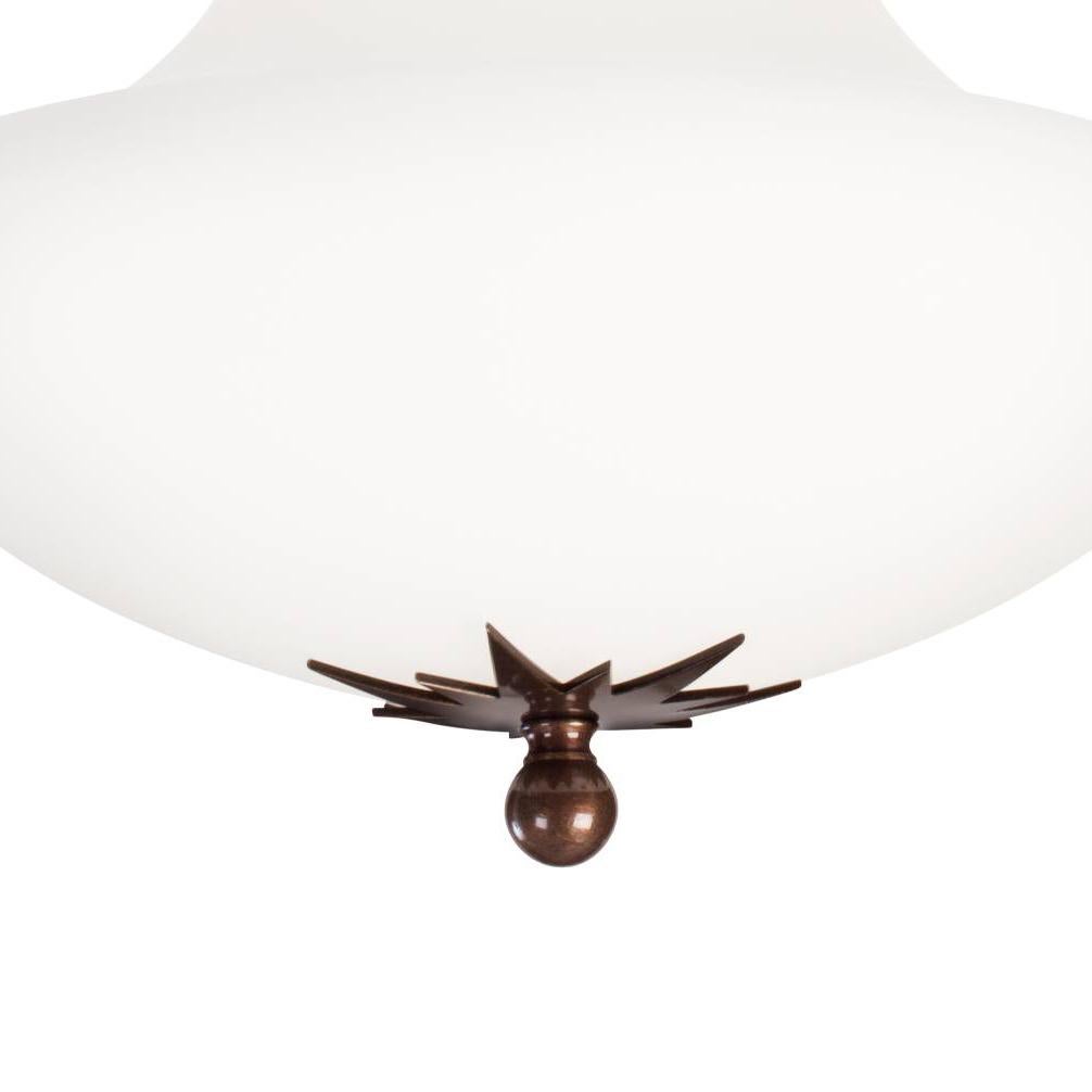 Ceiling lamp model Stoby designed by Konsthantverk and manufactured by themselves. 
A true Art Nouveau classic in white matte opal glass and oxidized brass.
Comes in a number of different sizes.

The production of lamps, wall lights and floor lamps