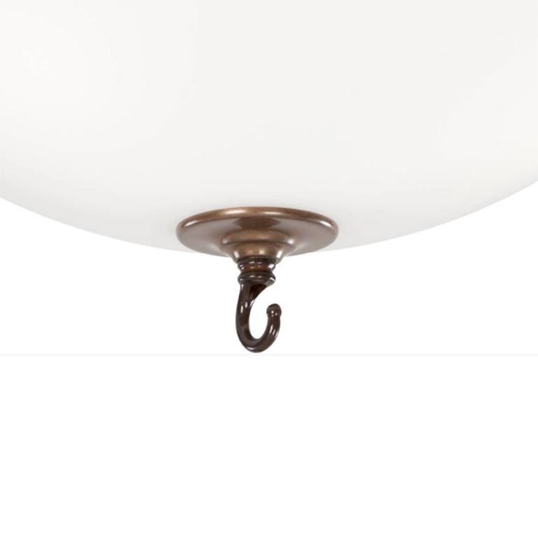 Ceiling lamp model Stävie designed by Konsthantverk and manufactured by themselves. 

Flush mount lamp in matte white glass and metal. Works on its own, or to hold a chandelier (the ceiling cup has a connection terminal). Includes both open hook