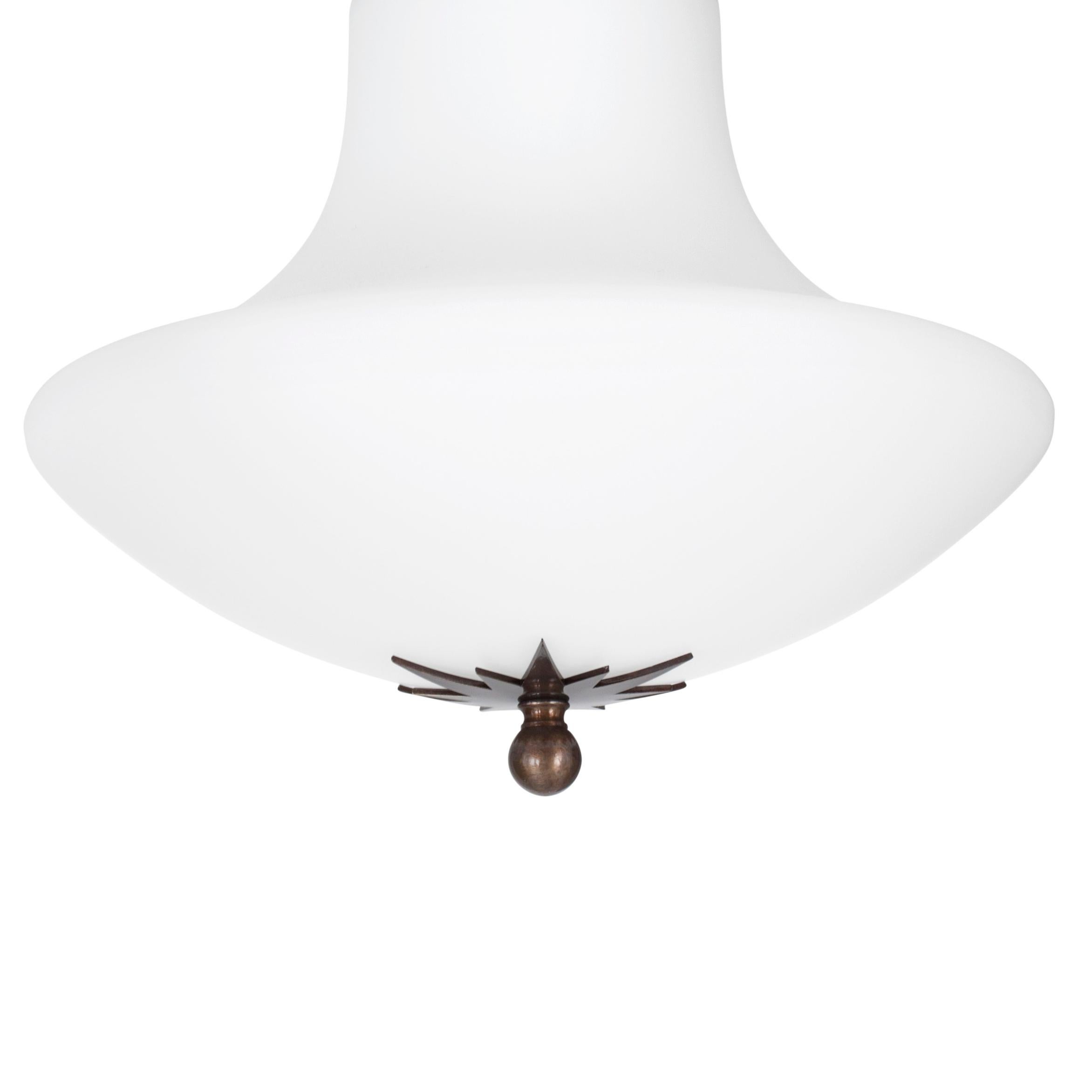 Ceiling lamp model Stoby designed by Konsthantverk and manufactured by themselves. 
A true Art Nouveau classic in white matte opal glass and oxidized brass.
Comes in a number of different sizes.

The production of lamps, wall lights and floor