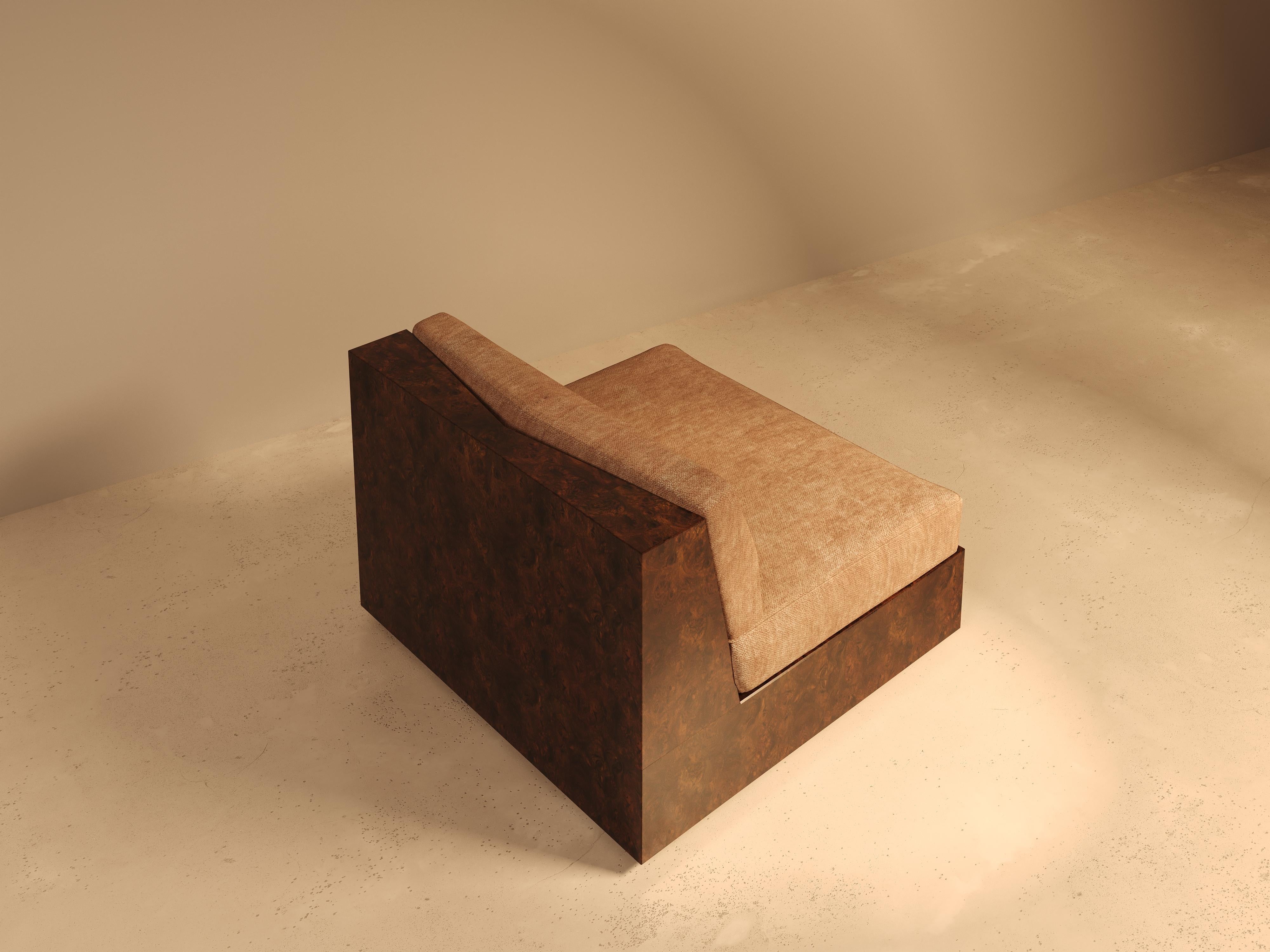 This piece is part of our Koohdasht collection, a modular sofa system created for evolving interiors. Shown here as a single unit, it features a high gloss burl wood base. The swirling grain of the wood brings natural depth and a quiet opulence,
