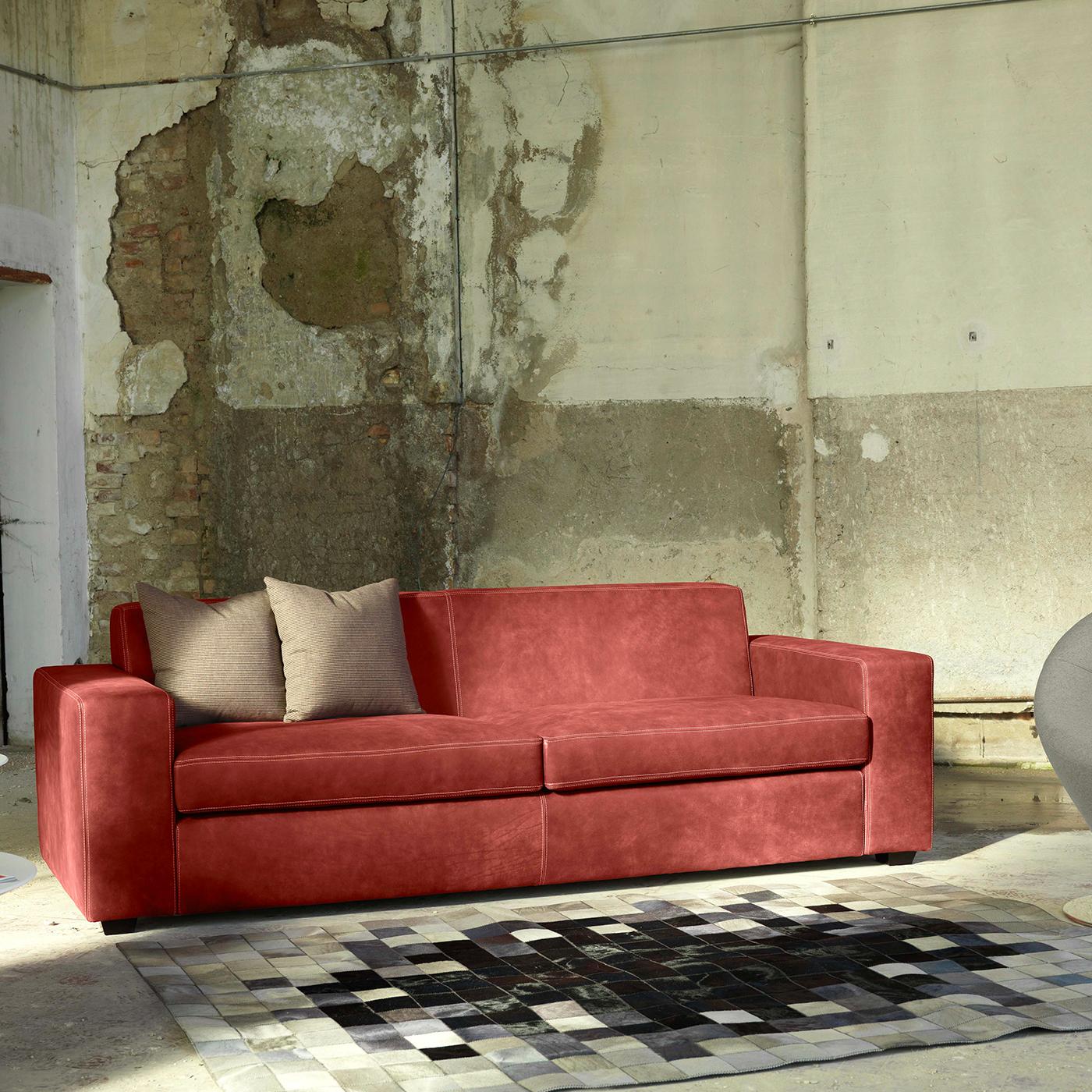 The perfect mix of pleasing aesthetics and comfort, this refined sofa flaunts a Classic Silhouette upholstered in brick red Dacron fabric with tone-on-tone stitching. Adding comfort to the wide seat, back, and generous track armrests, the