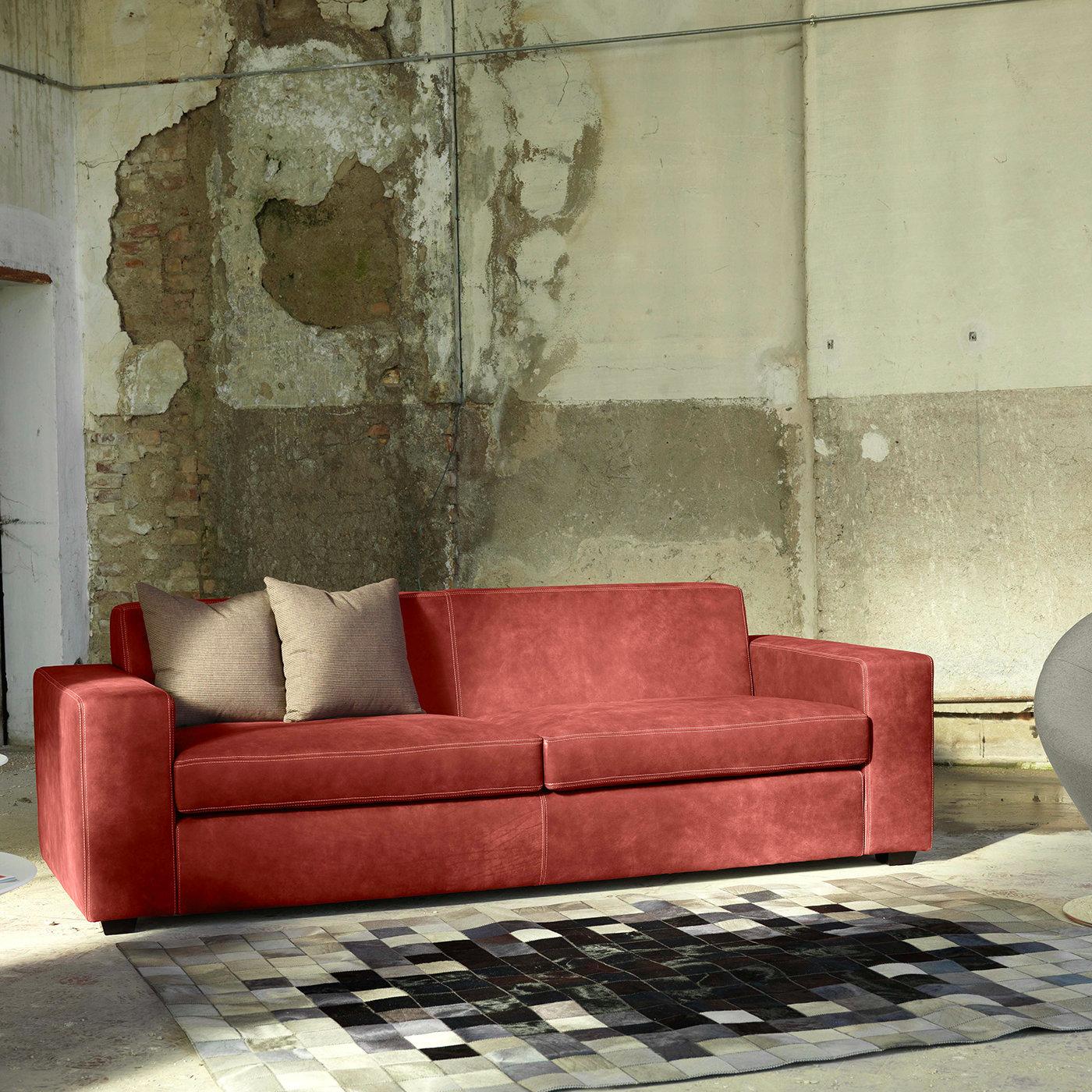 The perfect mix of pleasing aesthetics and comfort, this refined sofa flaunts a classic silhouette upholstered in brick red Dacron fabric with tone-on-tone stitching. Adding comfort to the wide seat, back, and generous track armrests, the