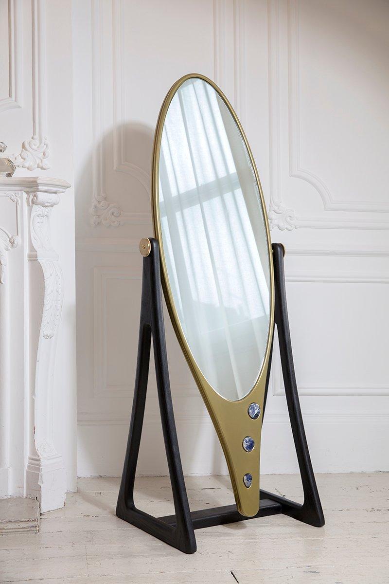 Blackened oak, liquid and solid brass, Corian and sodalite stones inset
Measures: Overall height 162 cm x width 59 cm base depth 47 cm
Mirror height 159 cm x width 48 cm x depth 4 cm.