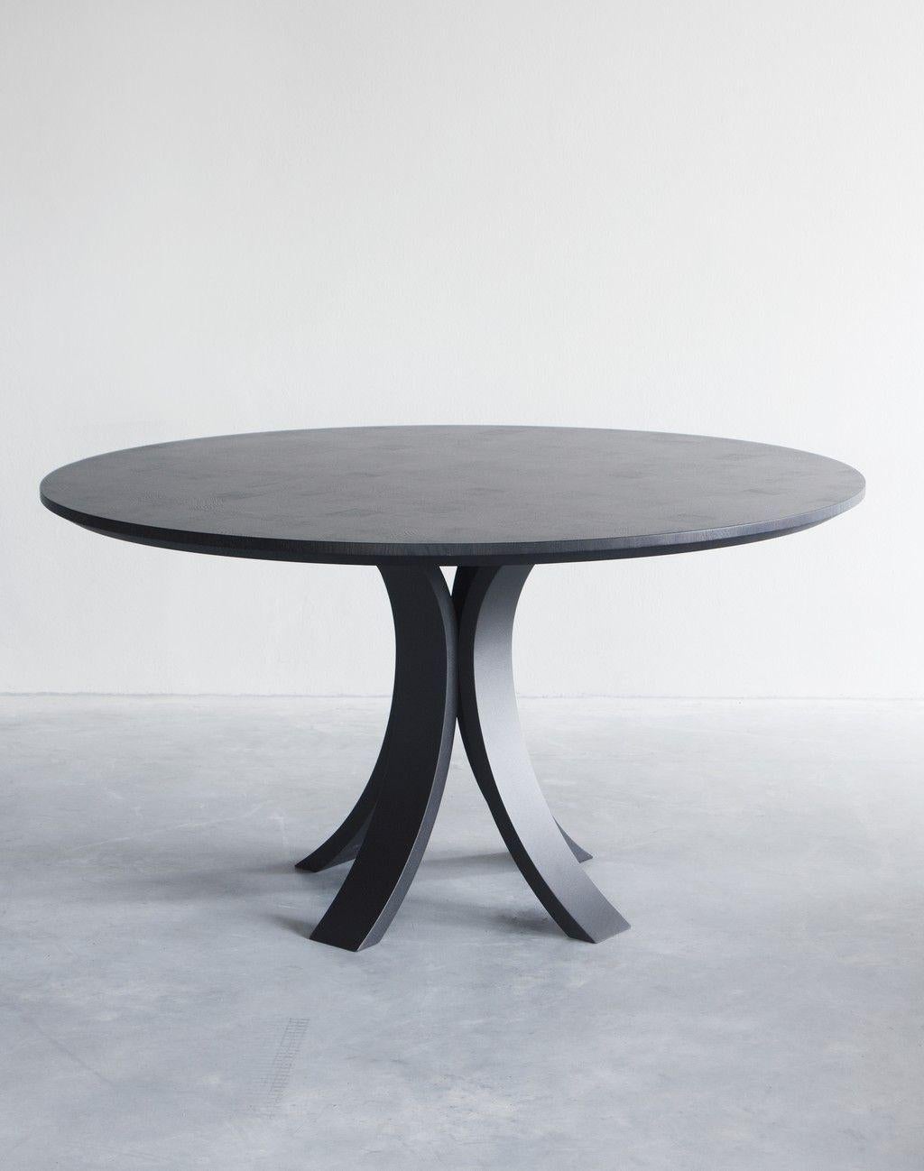 Kops Slim dining table round by Van Rossum.
Dimensions: D140 x W140 x H75 cm
Materials: Oak, Steel.
Also available in walnut. 

The wood is available in all standard Van Rossum colors, or in a matching finish to customer’s own sample.
The