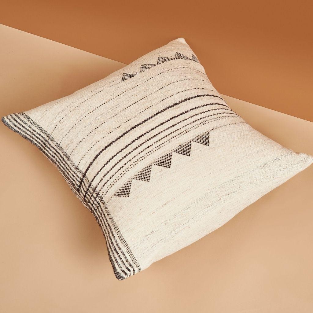 Kora Pillow is a slightly textured handwoven pillow where our artisans have skillfully blended handspun yarns like silk, wool and organic cotton. The beauty of this pillow is in its pure design that stands out with the use of undyed yarns left in