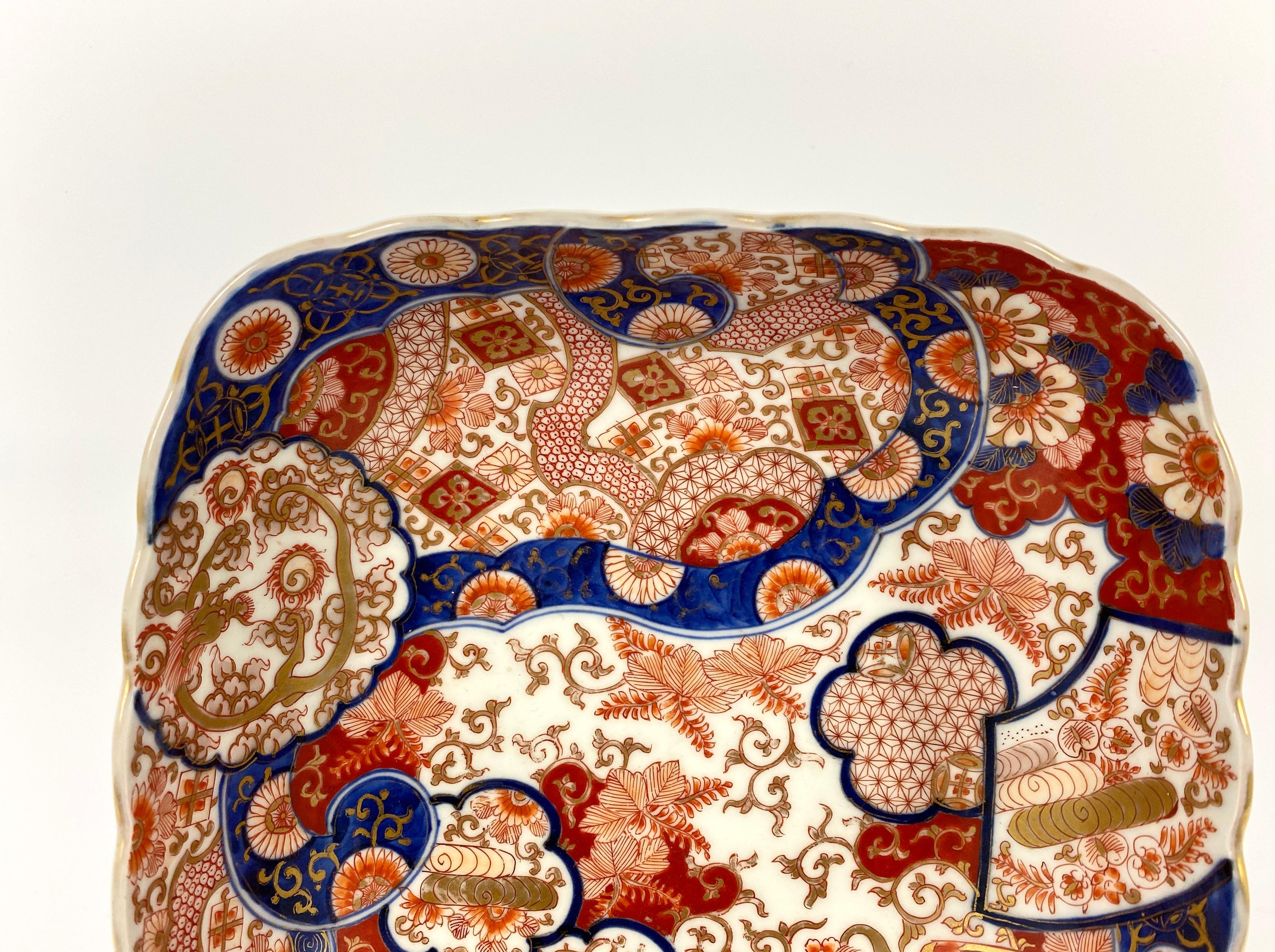 Koransha porcelain bowl, Japan, circa 1890, Meiji period. The square shaped bowl, boldly painted in the Imari style, with variously shaped, overlapping panels of dragons, flowers and textile motifs, upon similarly decorated larger panels.
The