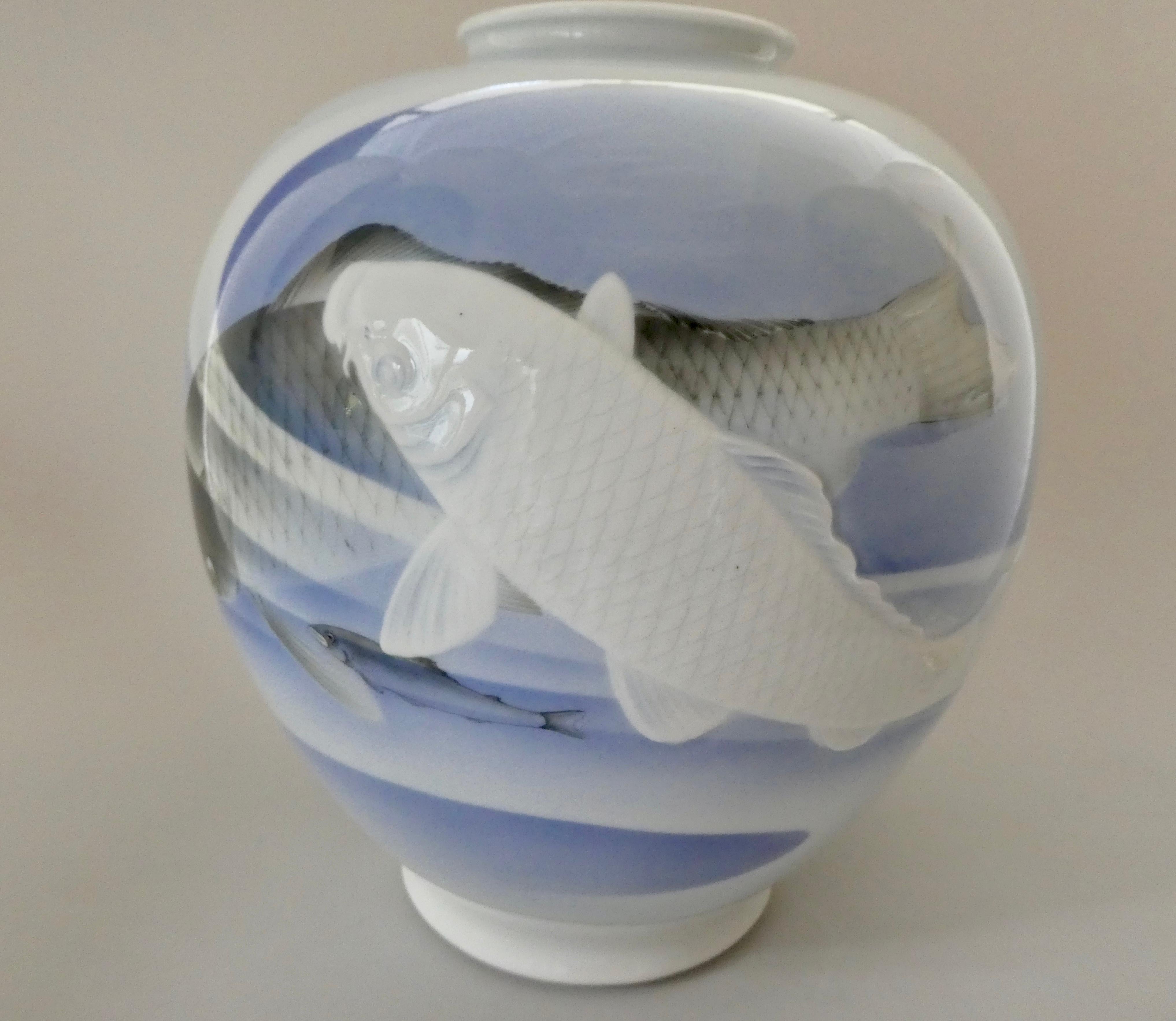 A fine and large Koransha porcelain vase, circa 1890, Meiji period. The globular vase, decorated with a primary scene of two large carp, swimming through gently rippling waters; the first carp in delicately, moulded relief, the second painted in