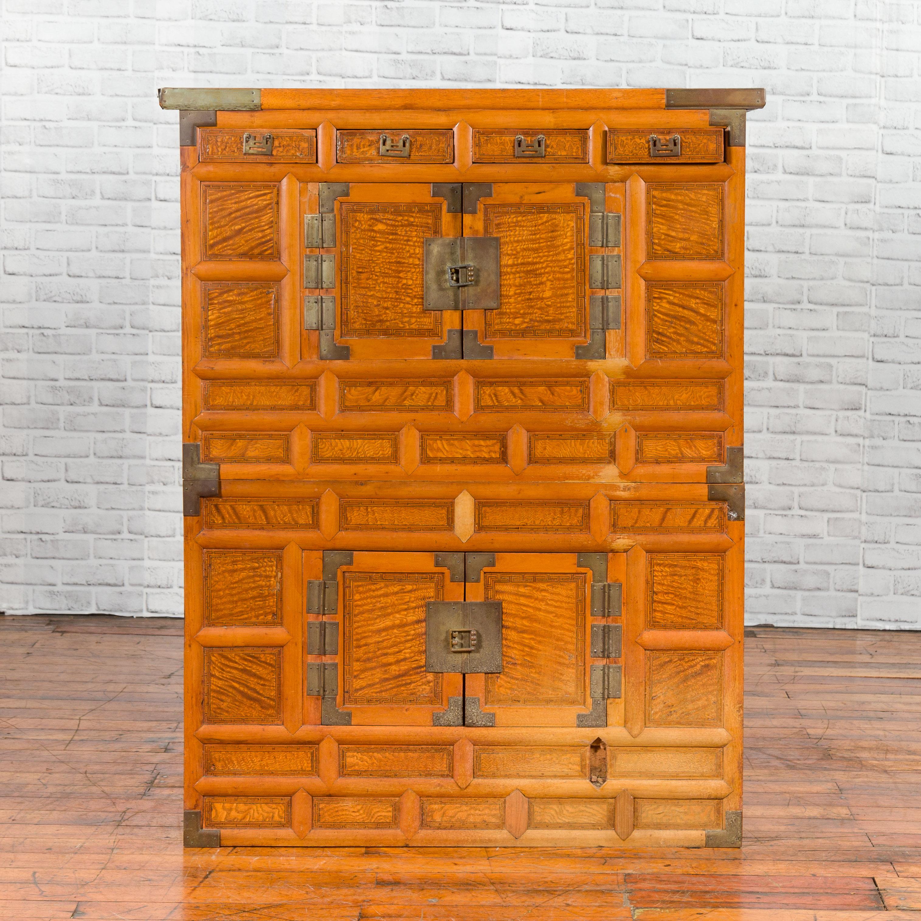 A Korean burl wood two-part cabinet from the 19th century, with brass fittings. Created in Korea during the 19th century, this cabinet, made of two parts, captures our attention with its burl wood finish accented with brass fittings. Made of drawers