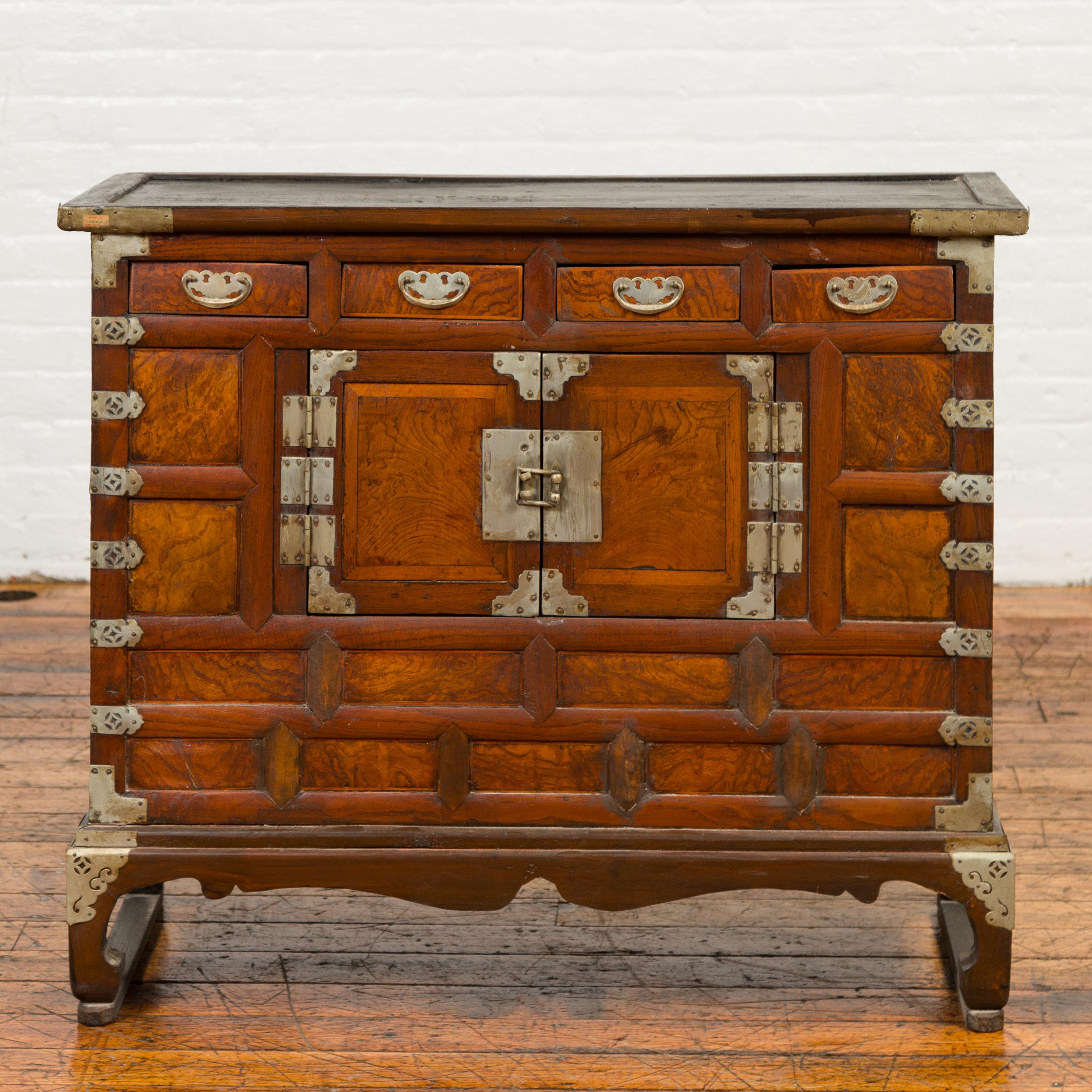 A Korean wooden side chest from the 19th century, with four drawers, double doors and white metal hardware. Born in Korea during the 19th century, this side chest features a rectangular top with slightly recessed central panel, sitting above a