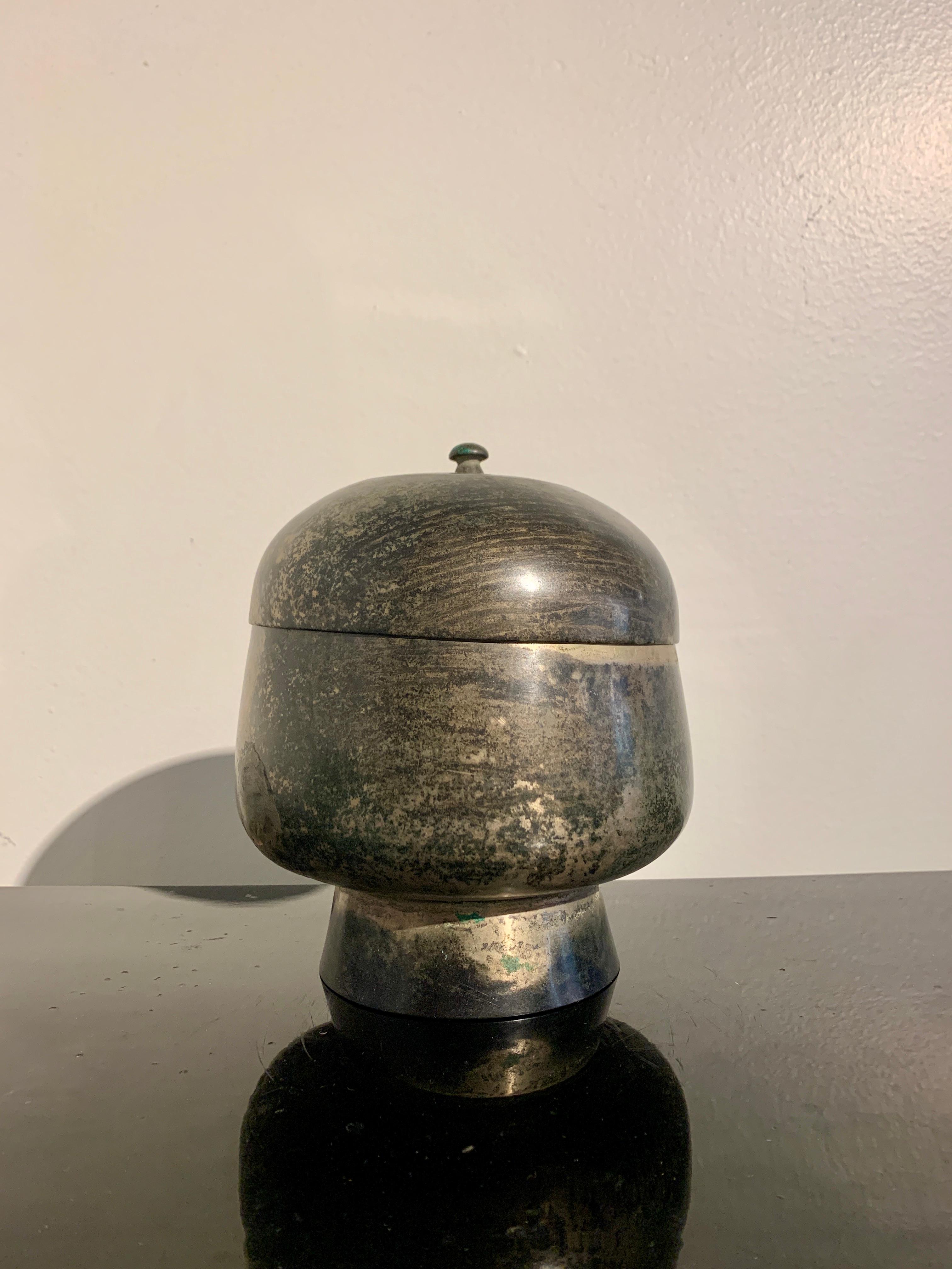 A fine and elegant bronze covered bowl, late Goryeo Dynasty, 12th - 13th century, Korea. 

The bowl features a bulbous body resting on a tall splayed pedestal foot. The body tapered upwards, and surmounted by a fitted lid with a small knob handle.