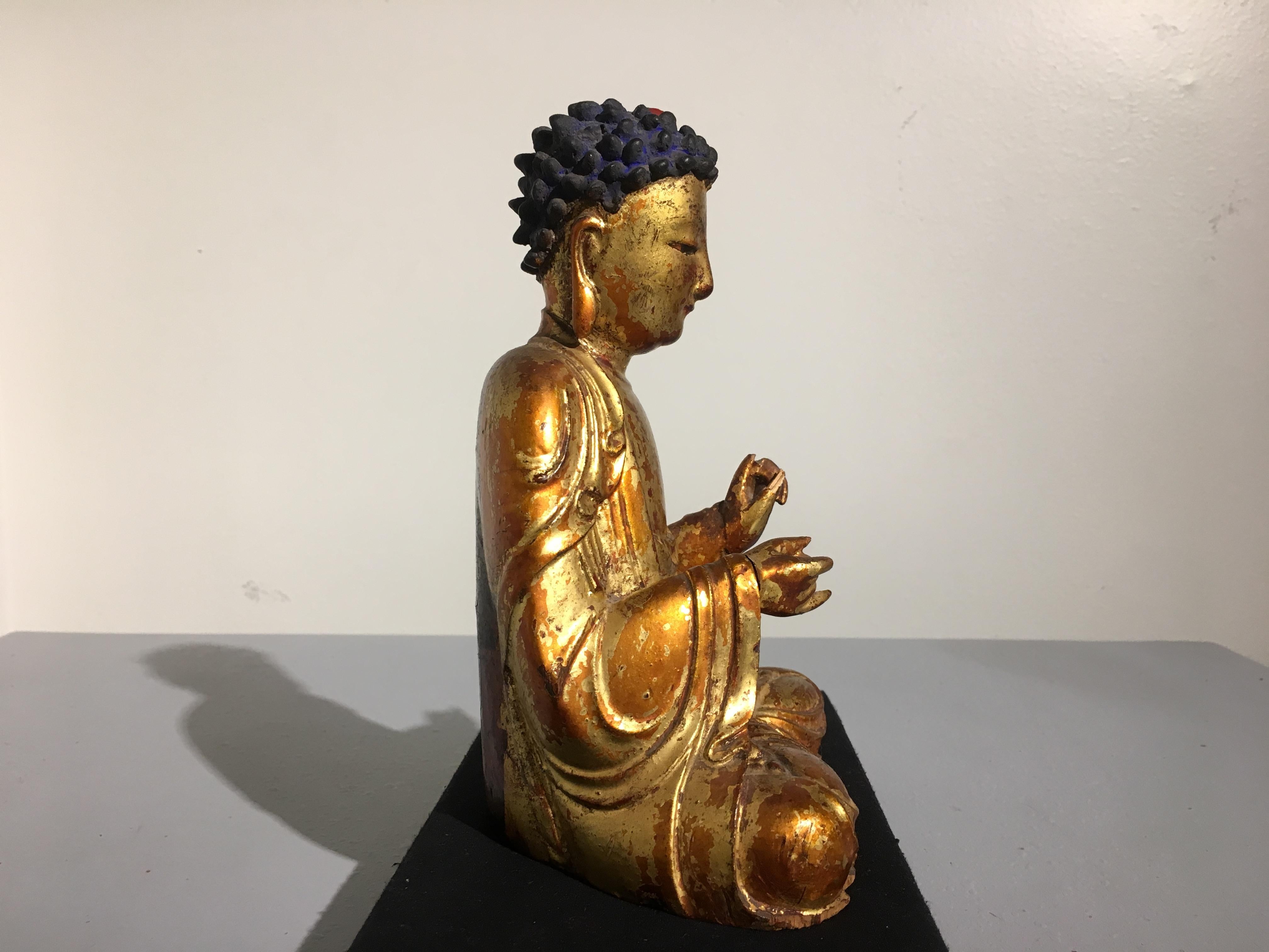 A sublime and well carved Korean lacquered and gilt wood figure of Amitabha Buddha (Amita Bul), Joseon Dynasty, early 19th century, Korea. 

The Buddha of Infinite Light and Lord of the Western Paradise, Amitabha Buddha, known as Amita Bul in