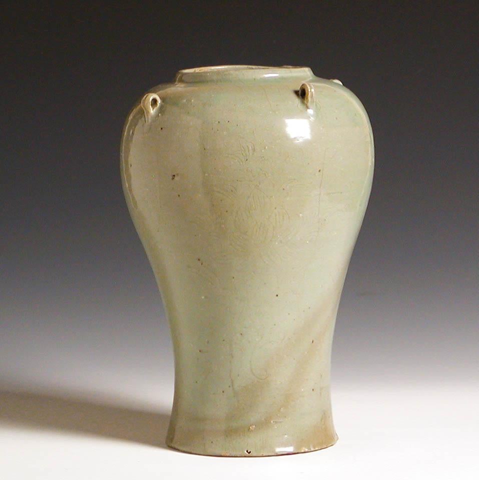 Korean incised celadon glazed baluster jar, stoneware with bulbous high shoulder form, with four small strap handles, short neck, flared base, unglazed foot rim, and four incised tree peony plants on the exterior covered overall in a thick celadon