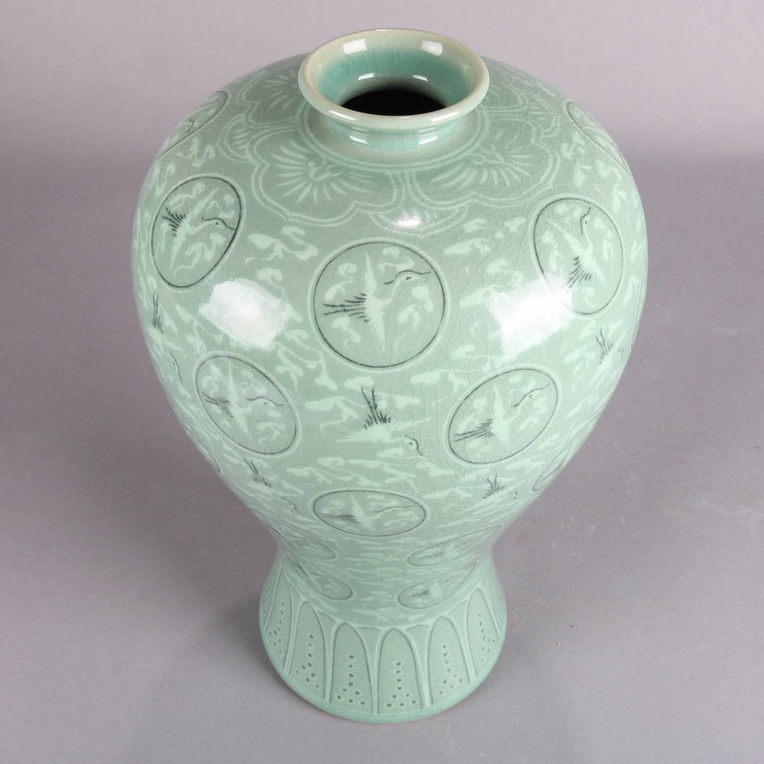 Korean celadon art pottery vase features allover heron and foliate design, floral collar and foliate base design, signed on base, 20th century

Measures: 13