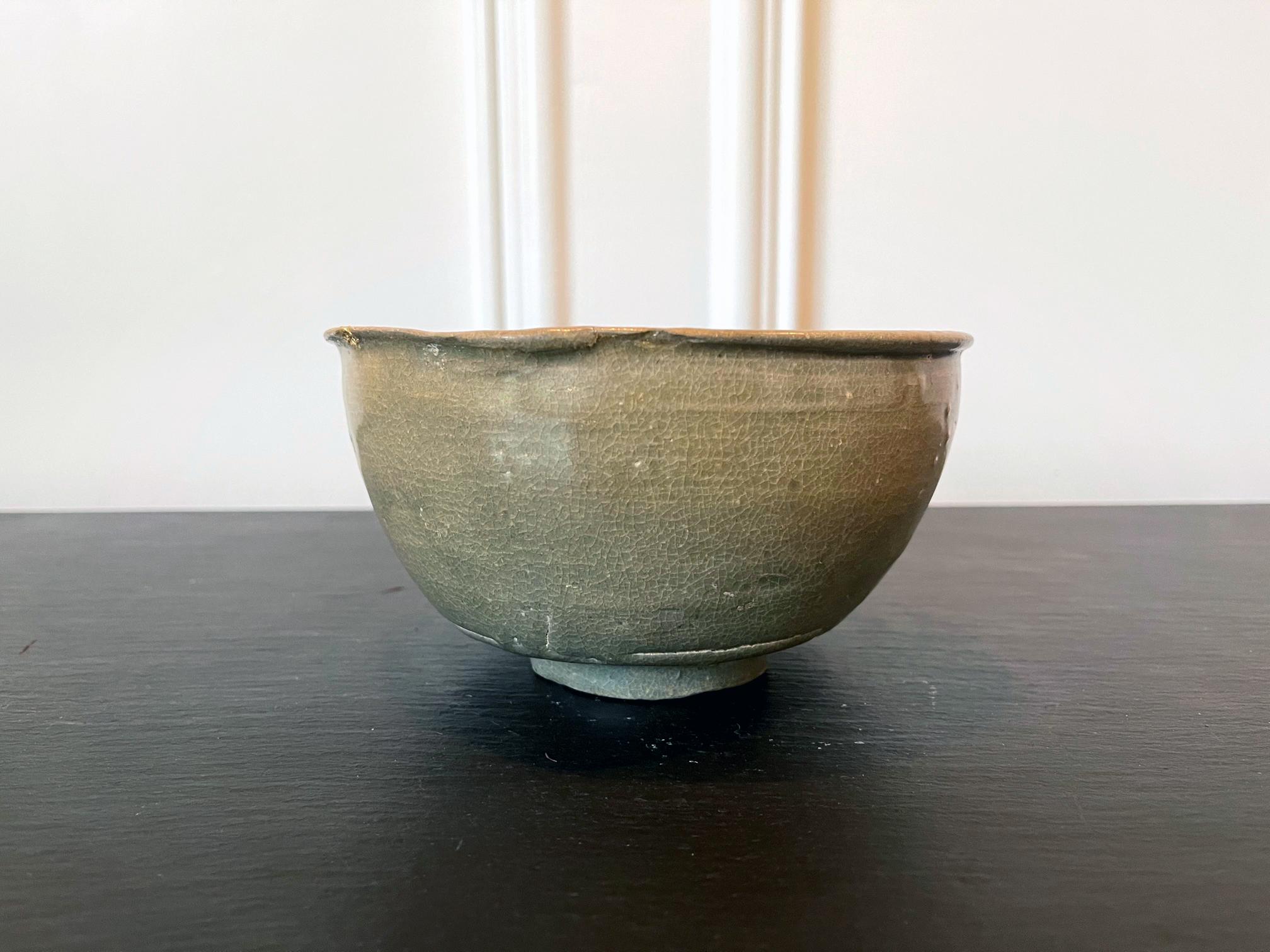 A ceramic bowl with celadon glaze from Korea, circa 14th century (late Goryeo Dynasty). The particular shape of the bowl suggests that it is likely a 