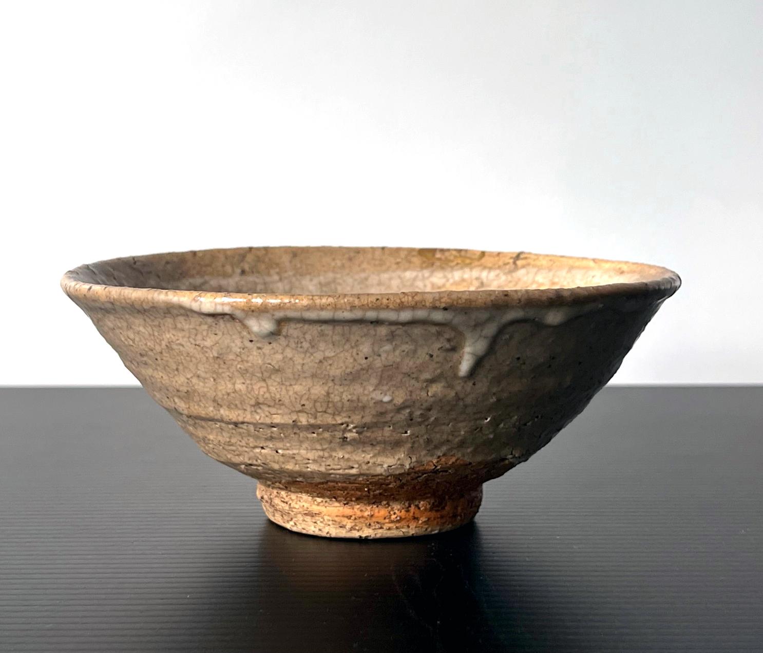 A ceramic stoneware chawan tea bowl made in Korea circa 16-17th century. The chawan is identified as Ko-ido (small ido) due to its size and form. Ido bowls were made since 15th century in Korea as everyday utensils for rice-eating and wine-drinking,