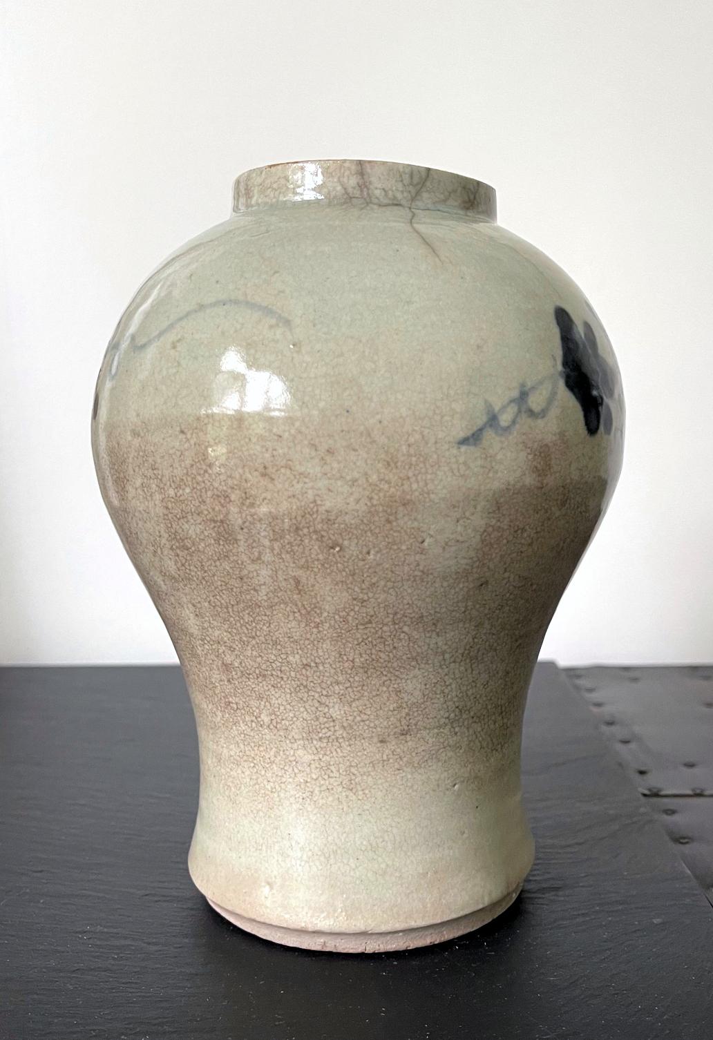 A Korean ceramic storage jar circa 18th century of Joseon Dynasty. The jar is of a characteristic form with a bulbous upper body that tappers with a graceful concave to the foot (a form known as Maebyong in Korea and Plum Vase in Chinese). An