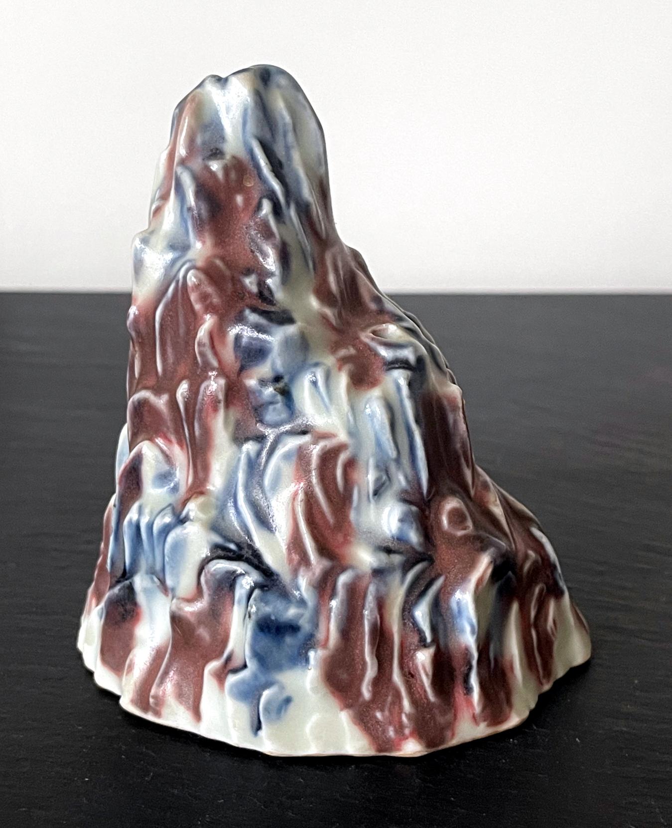 A Korean ceramic water dropper in the shape of a mountain from late Joseon Dynasty circa 1850-1900s. The lovely piece takes a shape of a rugged mountain peak with crags and furrows, hand-shaped by the potter. The surface was applied with blue and