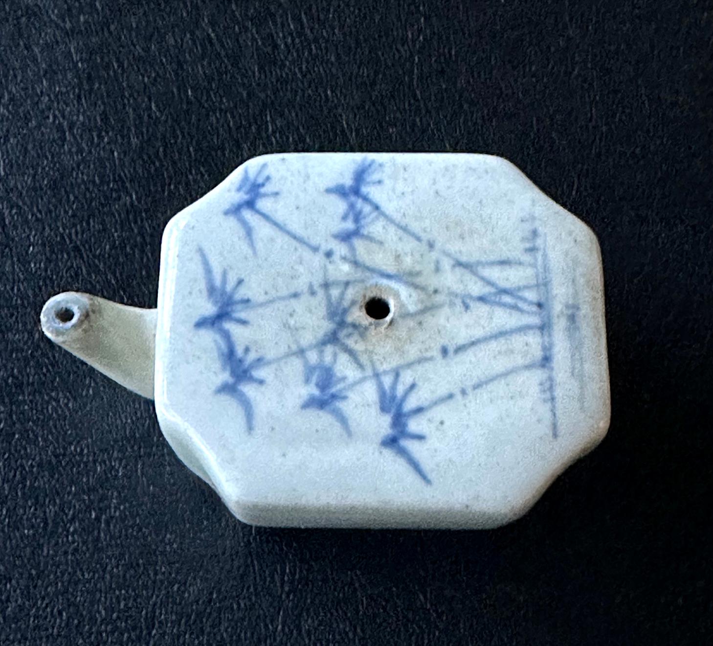 A small Korean water dropper in rectangular form with beveled edges, circa early 19th century of the Joseon Dynasty. The milky white porcelain piece was molded in a sensible form with an elongated curvy sprout extended on one end and the refill hole