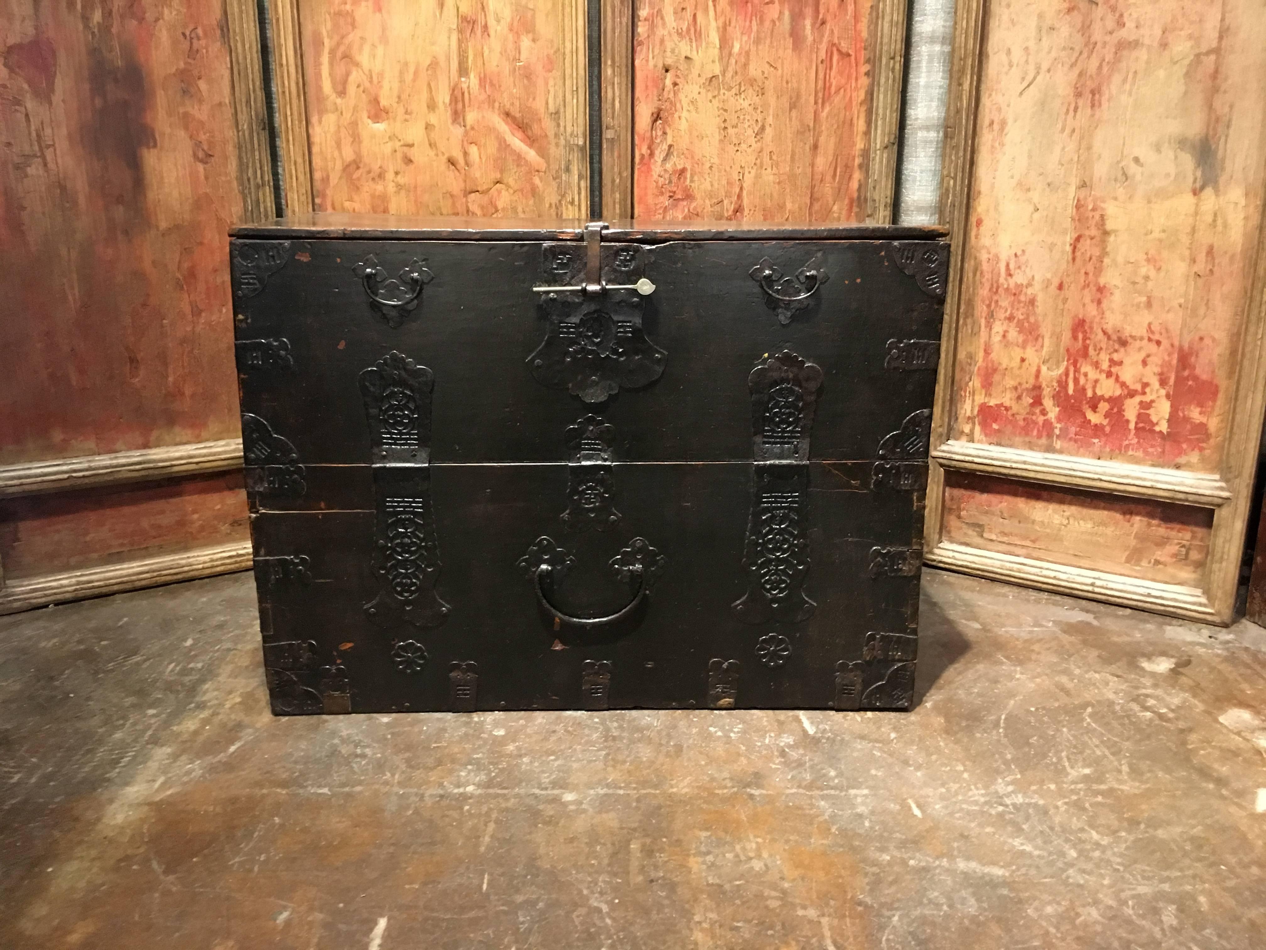 A stunning Korean bandaji, or blanket chest, crafted from elm wood, lacquered, and mounted with iron fittings, Joseon Dynasty late 18th or early 19th century. 

The elegantly simple rectangular form featuring a drop front mounted with gorgeous