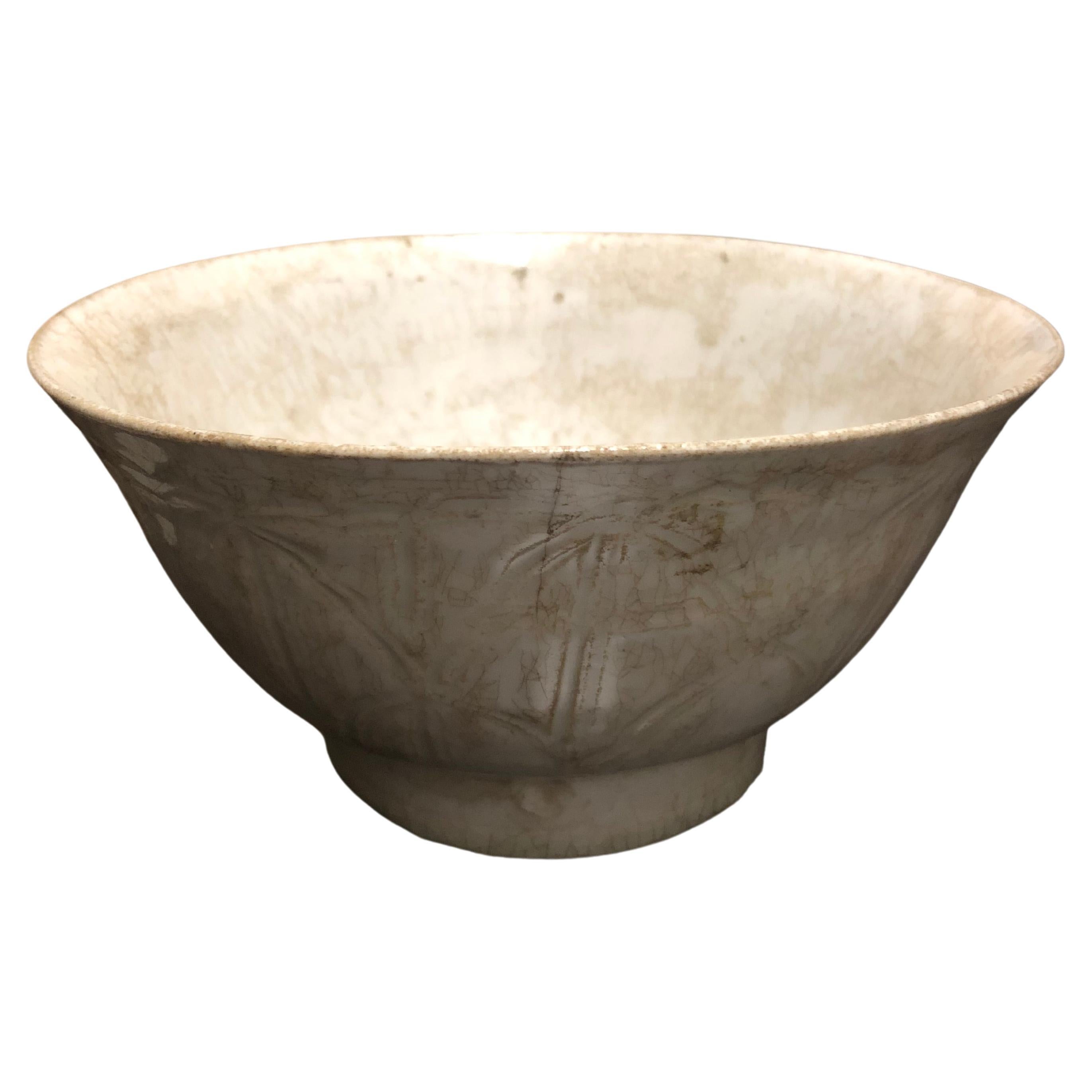 A finely thin potted white glazed bowl, with incised lotus blossom pattern decoration from the Joseon period, Korea, circa 1400.

It has an old collection number inscribed in pen on the inside of the foot of the bowl.

This bowl is structurally