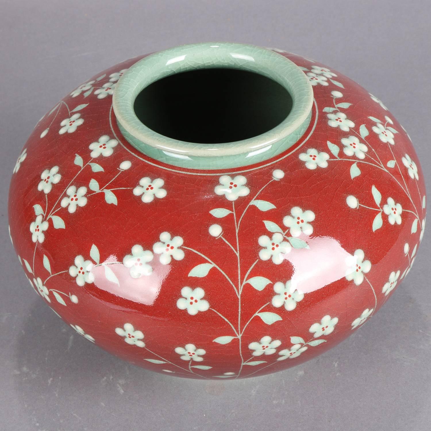 Korean celadon art pottery vase features bulbous form with all-over and raised cherry blossom decoration on Vermillion ground, chop mark signed and stamped on base, 20th century

Measures: 6