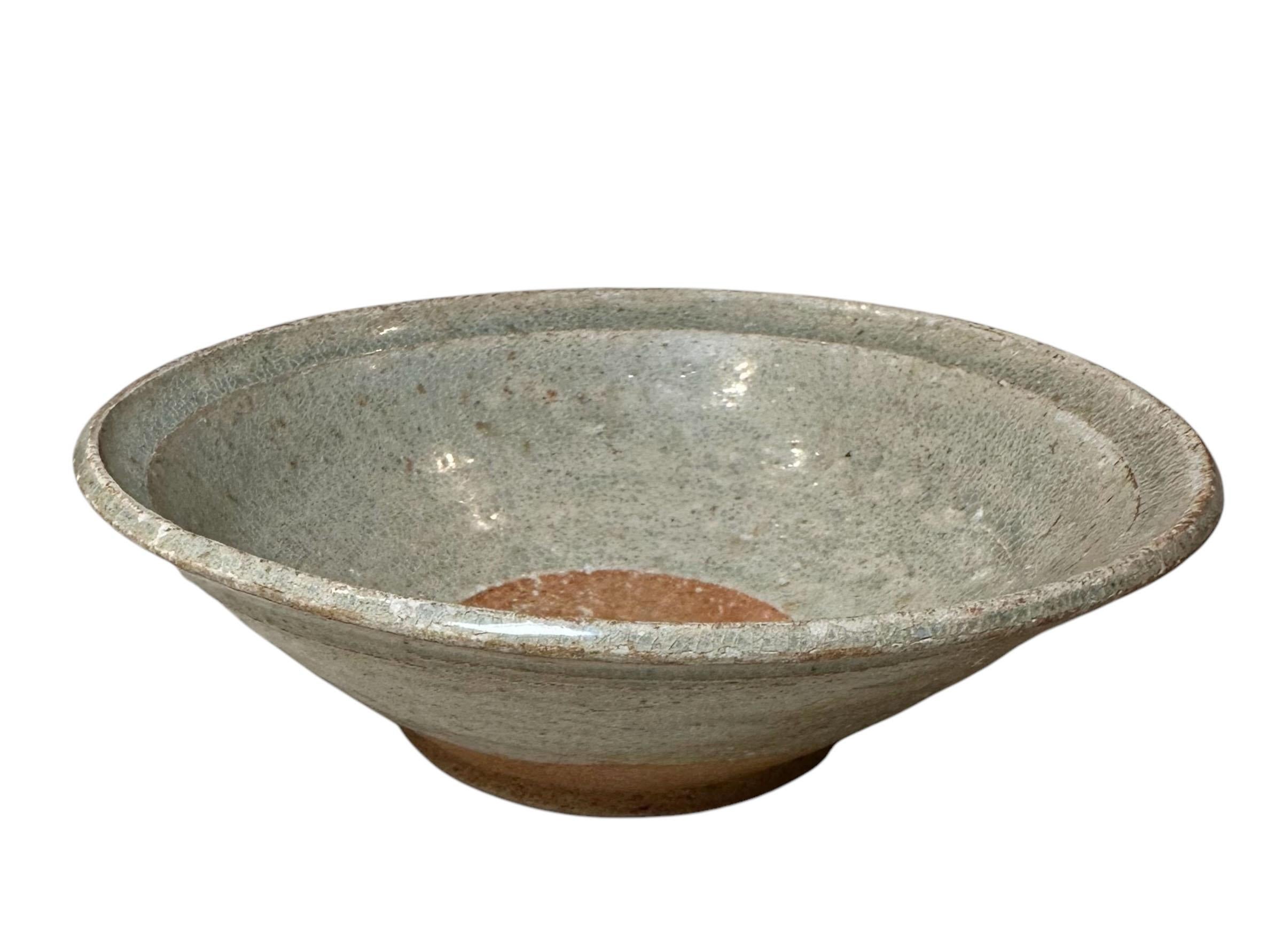 A Korean Joseon Dynasty glazed ceramic bowl. It is a celadon color. The Joseon Dynasty, circa 1392-1897. 