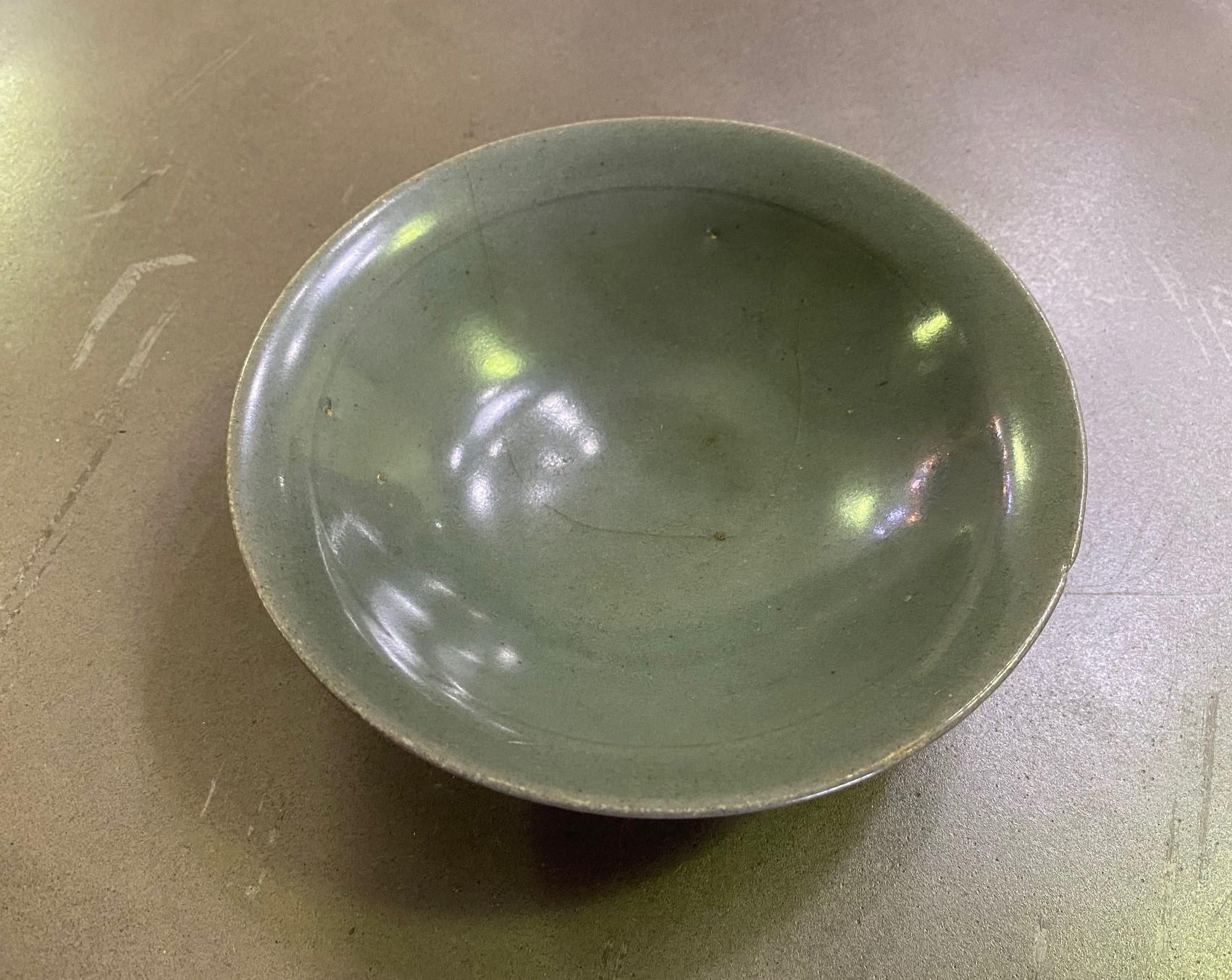 A wonderful Joseon Dynasty (1392-1897) Korean pottery bowl/ dish with a beautiful muted glaze, color, and nicely aged patina. 

As this is not our area of expertise, we are listing it simply as 19th century but it could very well be much older.