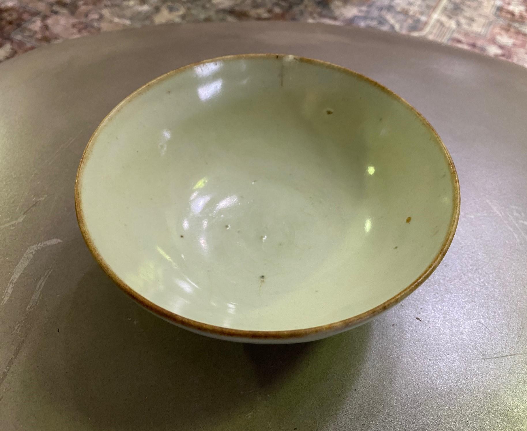 A wonderful Joseon Dynasty (1392-1897) Korean pottery bowl with a beautiful muted glaze, color, and nicely aged patina. 

As this is not our area of expertise, we are listing it simply as 19th century but it could very well be much older.