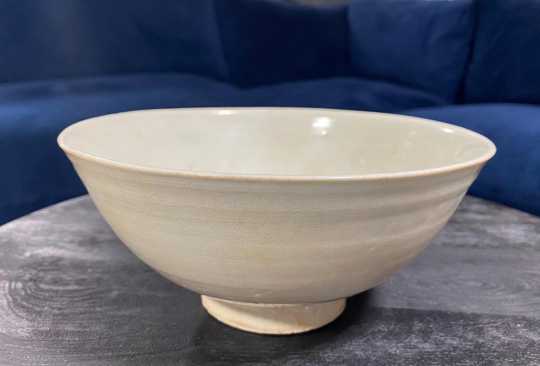 A wonderful Joseon Dynasty (1392-1897) Korean pottery bowl - perhaps a monk's Chawan tea bowl. The work features a beautiful white glaze, wonderful organic shape, engaging design and nicely aged patina. 

As this is not our area of expertise, we