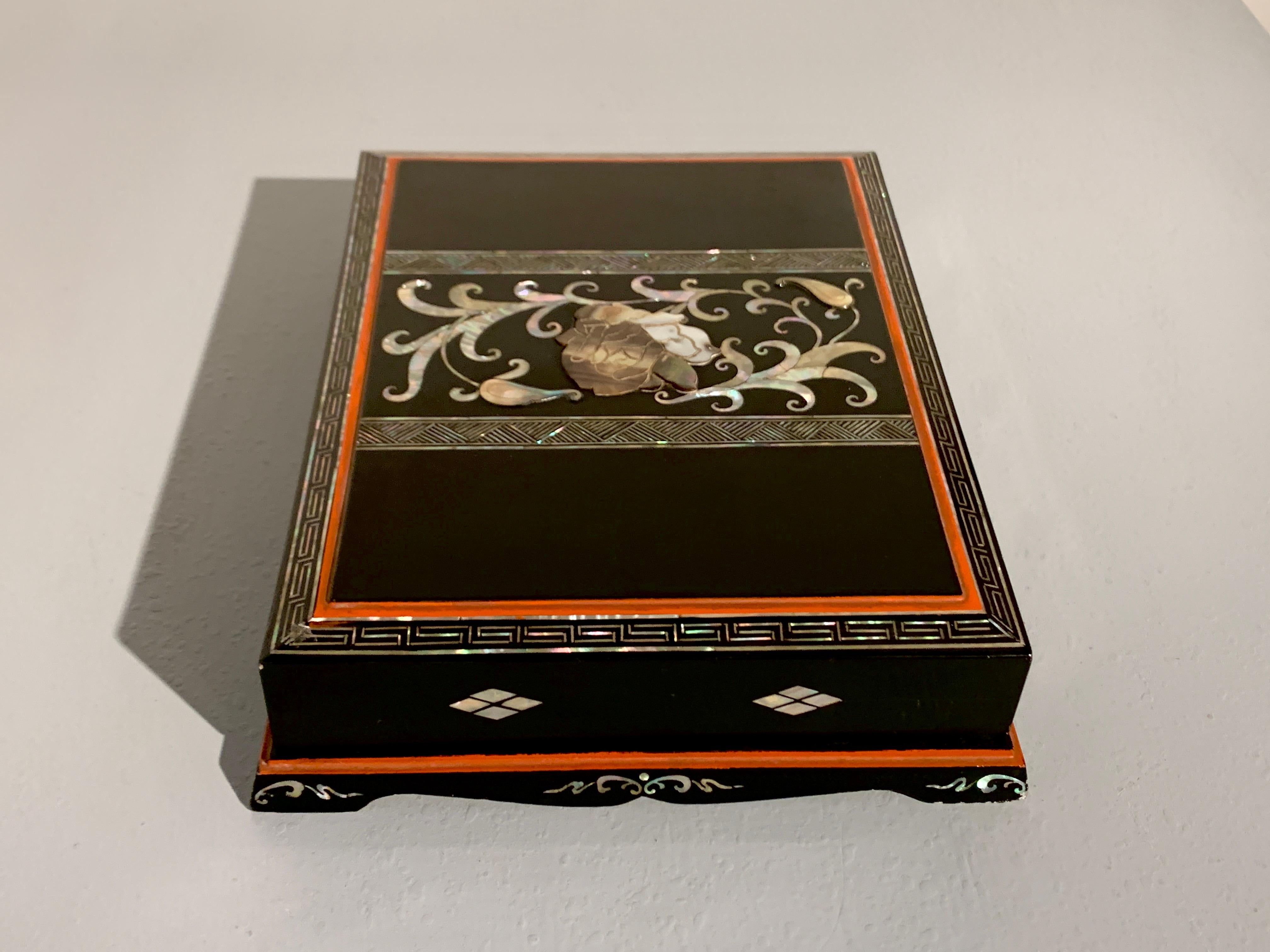 A bold Korean Art Deco lacquer and mother of pearl inlay stationery or writing box, circa 1920, Japanese occupied Korea.

The stationery box of traditional rectangular form, and raised on a short platform with a shaped apron. The box decorated in