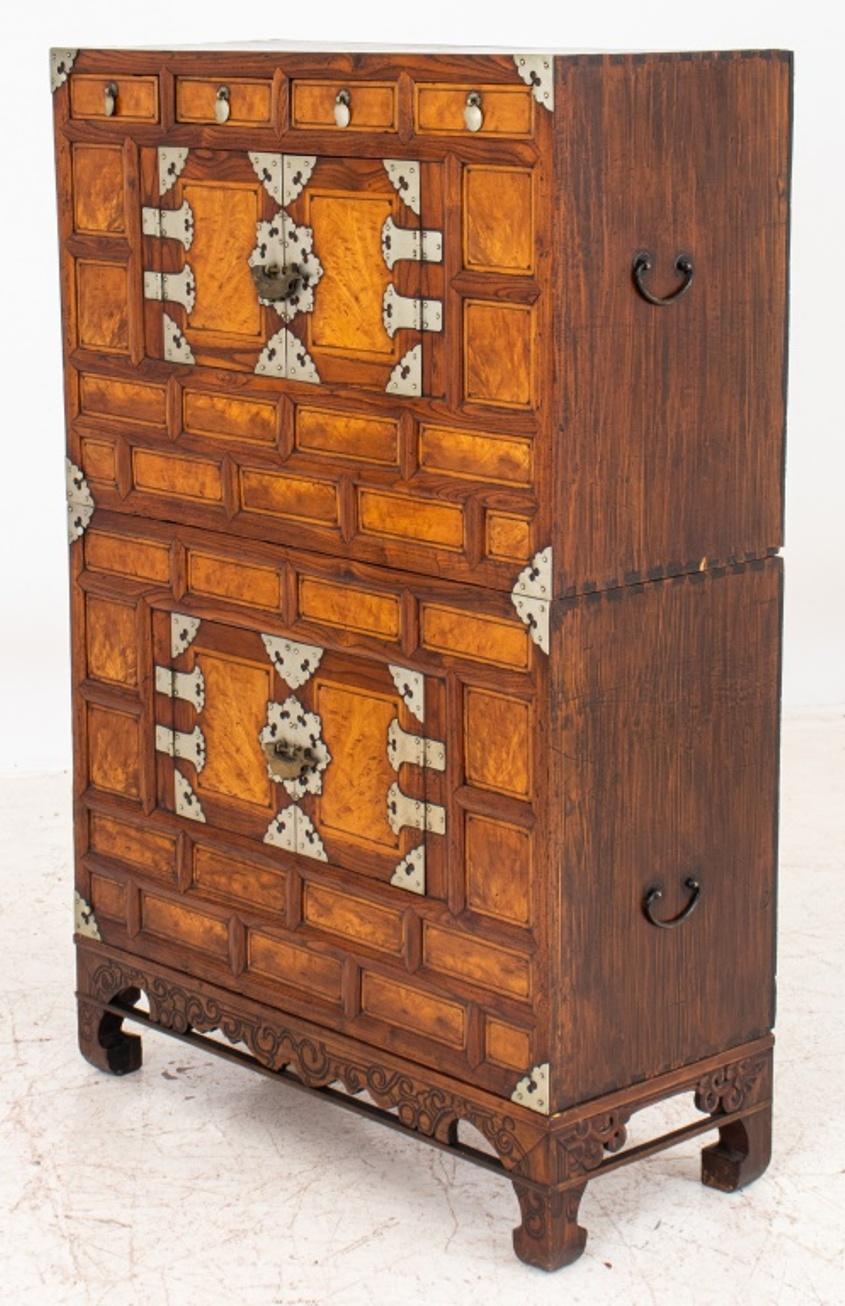 Korean antique locking chest on chest on stand in pine and persimmon woods, Joseon Dynasty, late 19th early 20th century, the upper chest with two central cabinet doors opening to reveal open interior, beneath four short drawres, the exterior